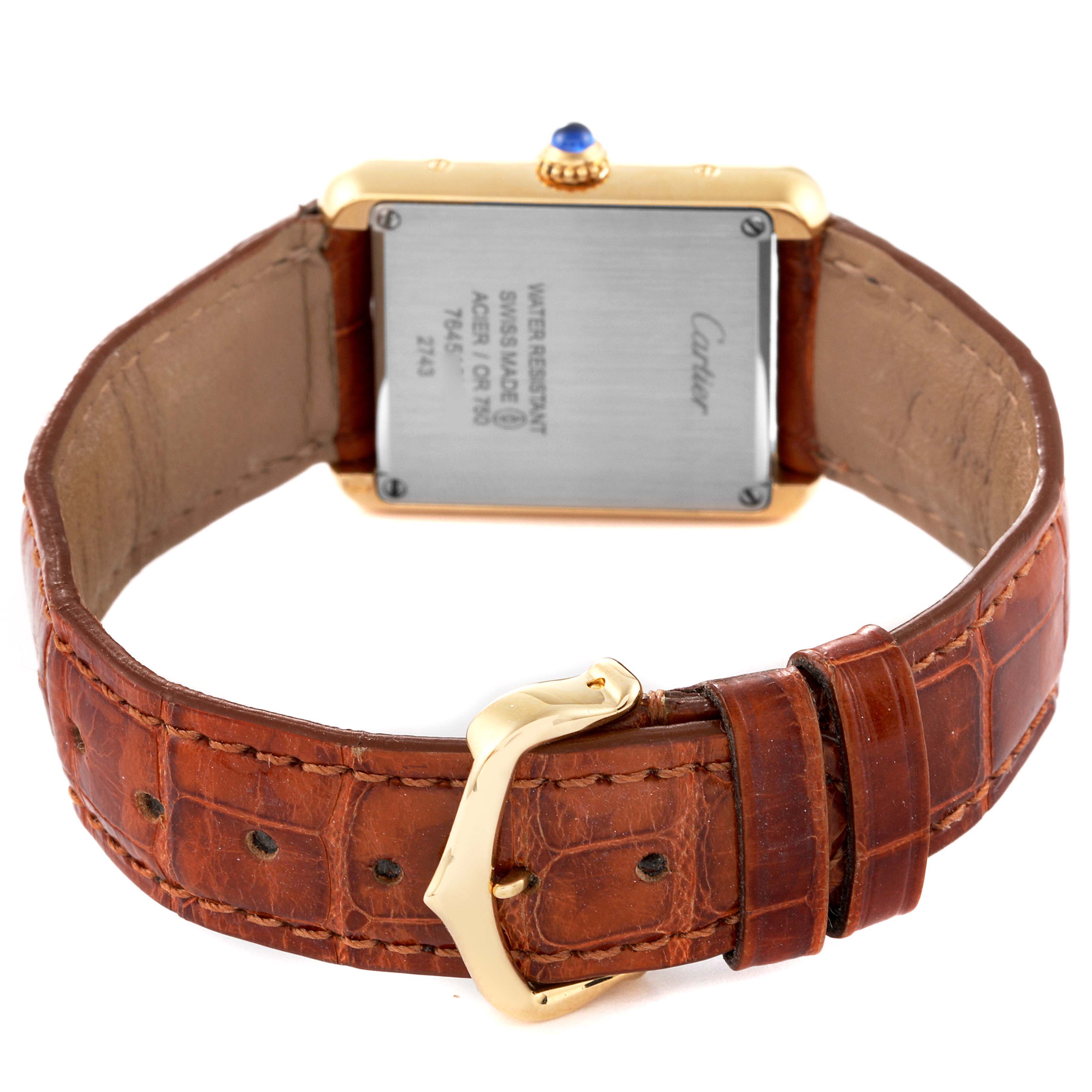 The image shows the back of the Cartier Tank Solo W1018755 Women's Yellow Gold Silver Dial W1018755 Women's Yellow Gold Silver Dial watch, including the case back, leather strap, and buckle.