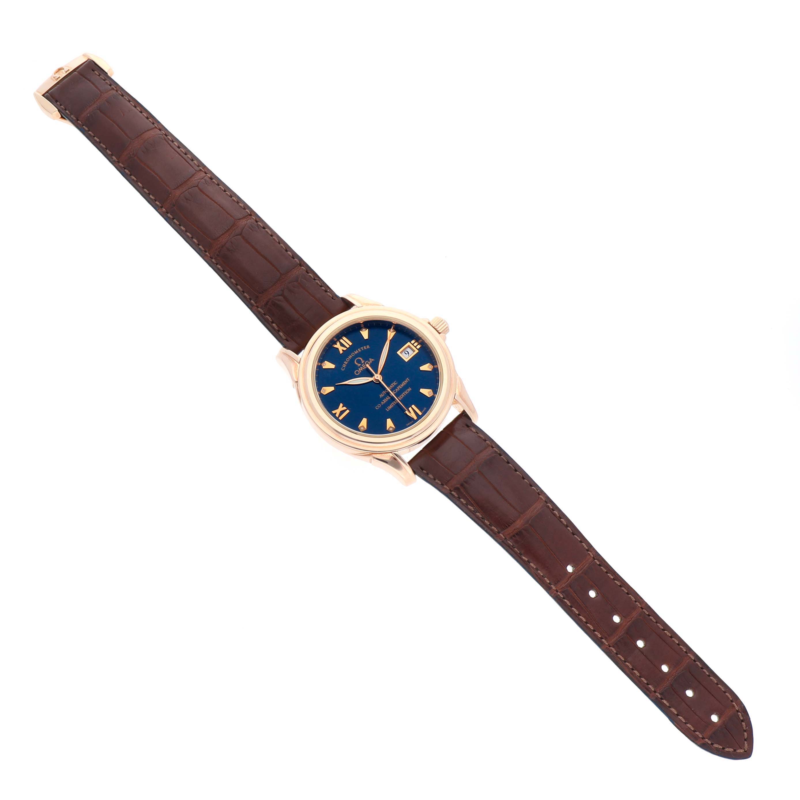 The Omega De Ville 5931.81.23 Men
s Rose Gold Blue Dial 5931.81.23 Men
s Rose Gold Blue Dial watch is shown from a top-down angle, displaying its blue dial, roman numerals, and brown leather strap.