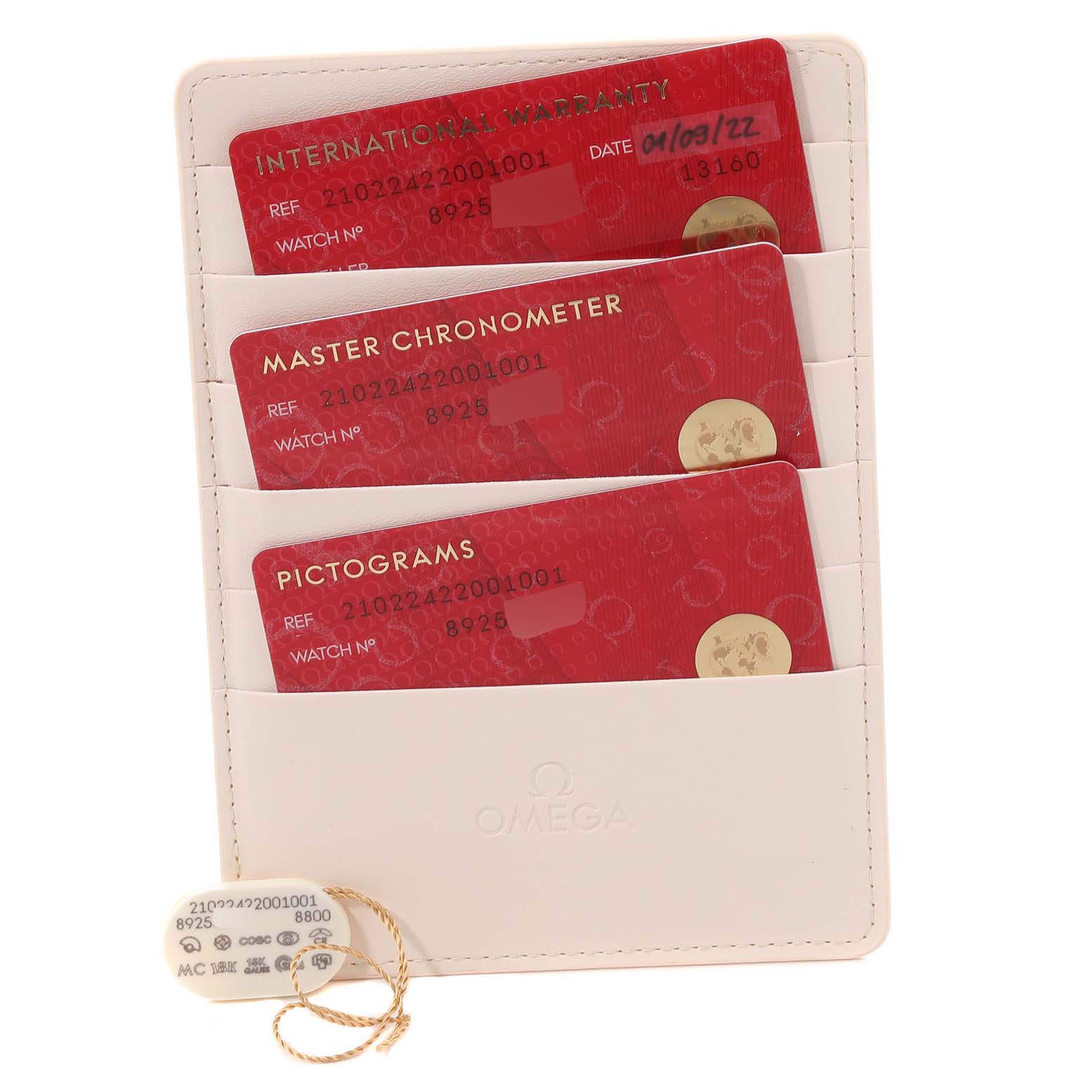 This image shows the warranty cards and a tag for the Omega Seamaster 210.22.42.20.01.001 Men's Steel and Gold (two tone) Black Dial 210.22.42.20.01.001 Men's Steel and Gold (two tone) Black Dial watch model.