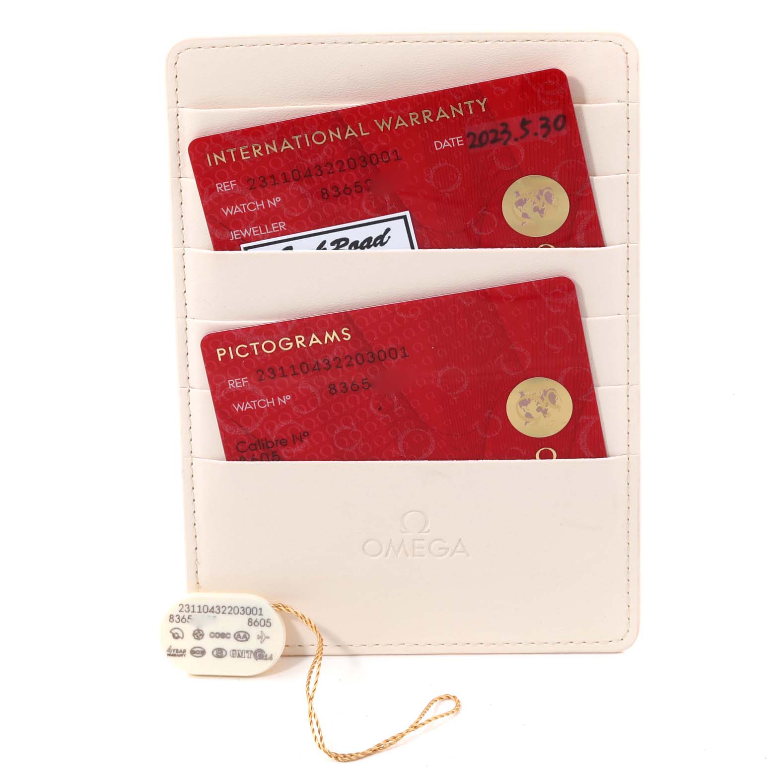 The image shows the International Warranty and Pictograms cards for the Omega Aqua Terra 231.10.43.22.03.001 Men
s Stainless Steel Blue Dial 231.10.43.22.03.001 Men
s Stainless Steel Blue Dial model, along with a tag, from a top-down angle.