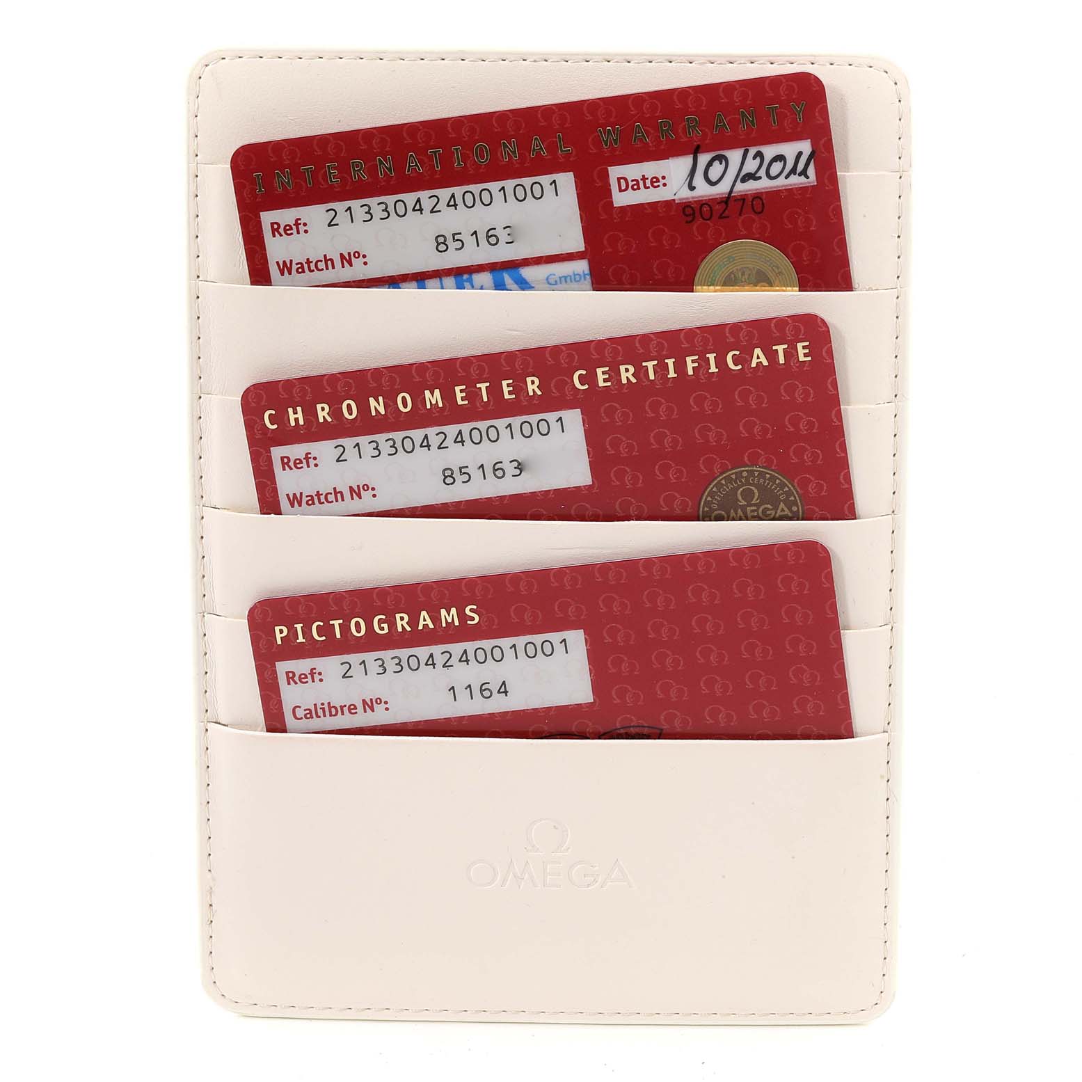 This image shows a white Omega card holder containing three cards: International Warranty, Chronometer Certificate, and Pictograms, for the Seamaster model.