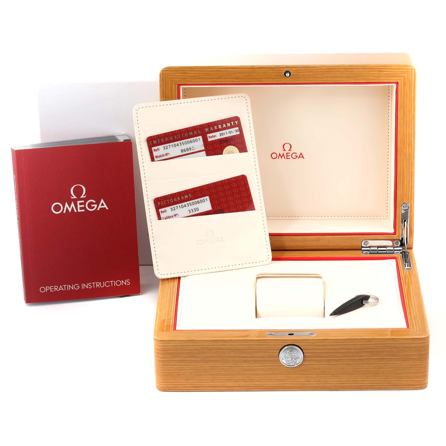 The image shows the accessories and packaging for an Omega Speedmaster 327.10.43.50.06.001 Men's Stainless Steel Grey Dial 327.10.43.50.06.001 Men's Stainless Steel Grey Dial, including the box, instruction manual, and warranty cards.