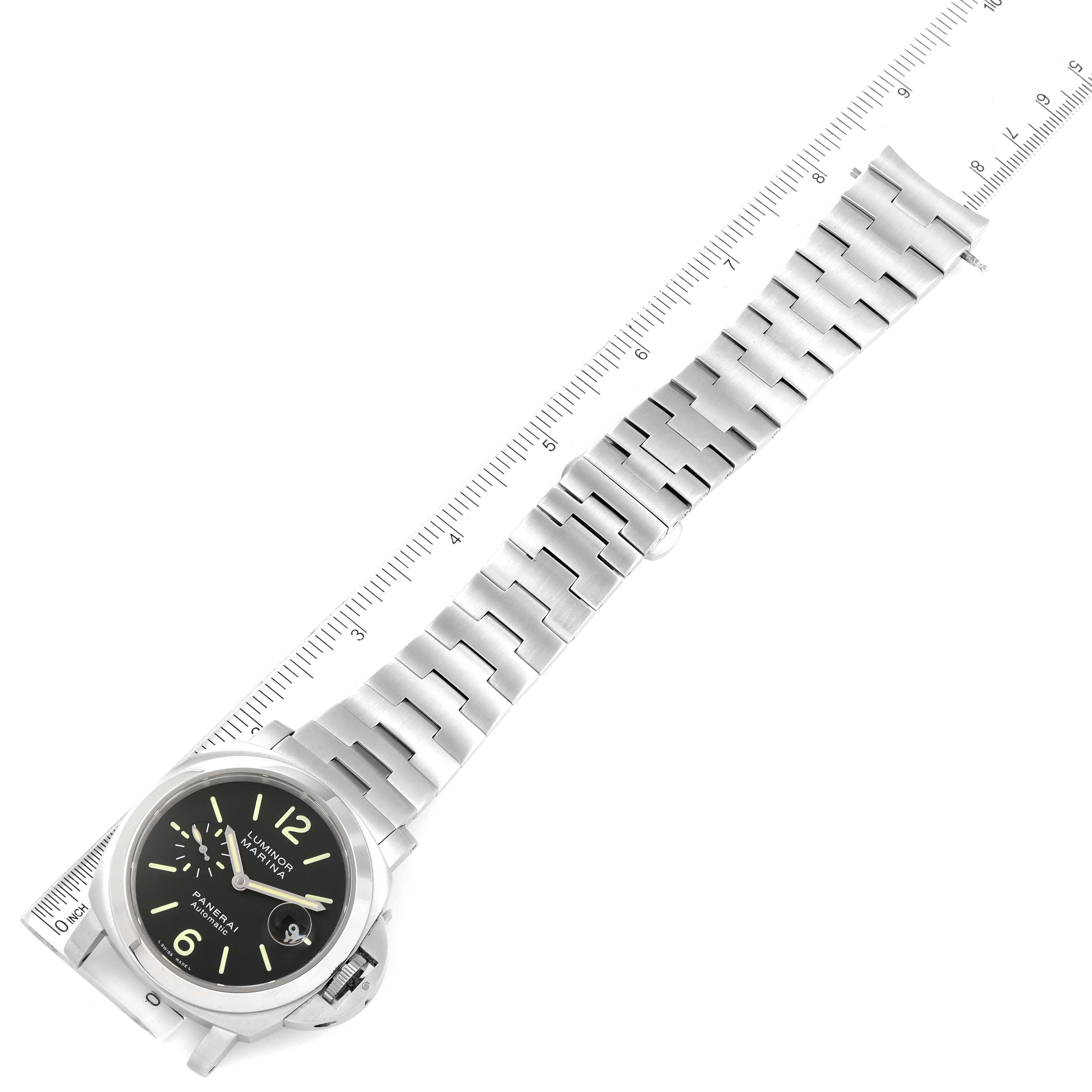 The image shows a Panerai Luminor PAM00299 Men
s Stainless Steel Black Dial PAM00299 Men
s Stainless Steel Black Dial watch laid flat at an angle, highlighting the dial, case, and metal bracelet alongside a ruler.