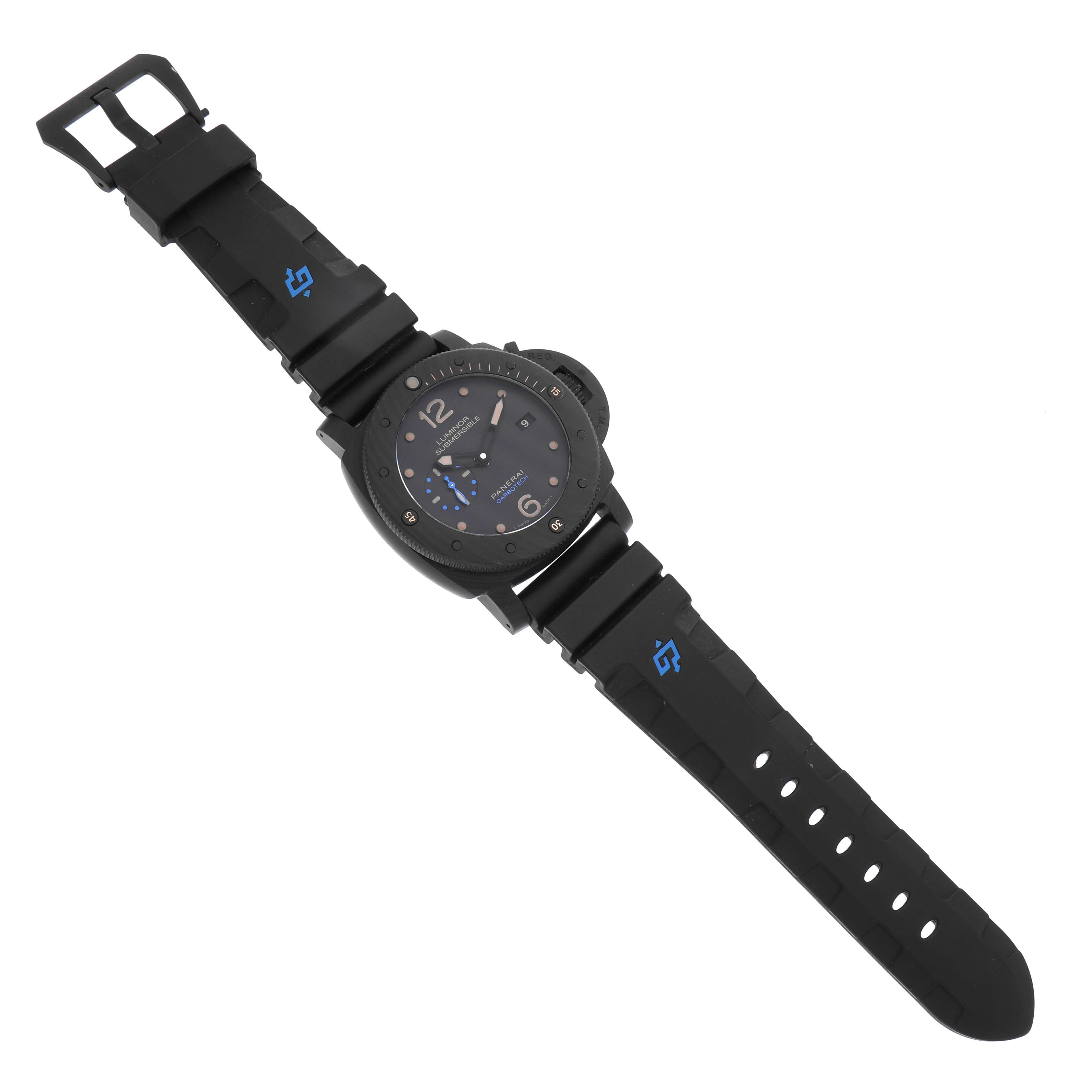 The Luminor by Panerai is shown from a top-down angle, highlighting the watch face and black rubber strap with blue accents.