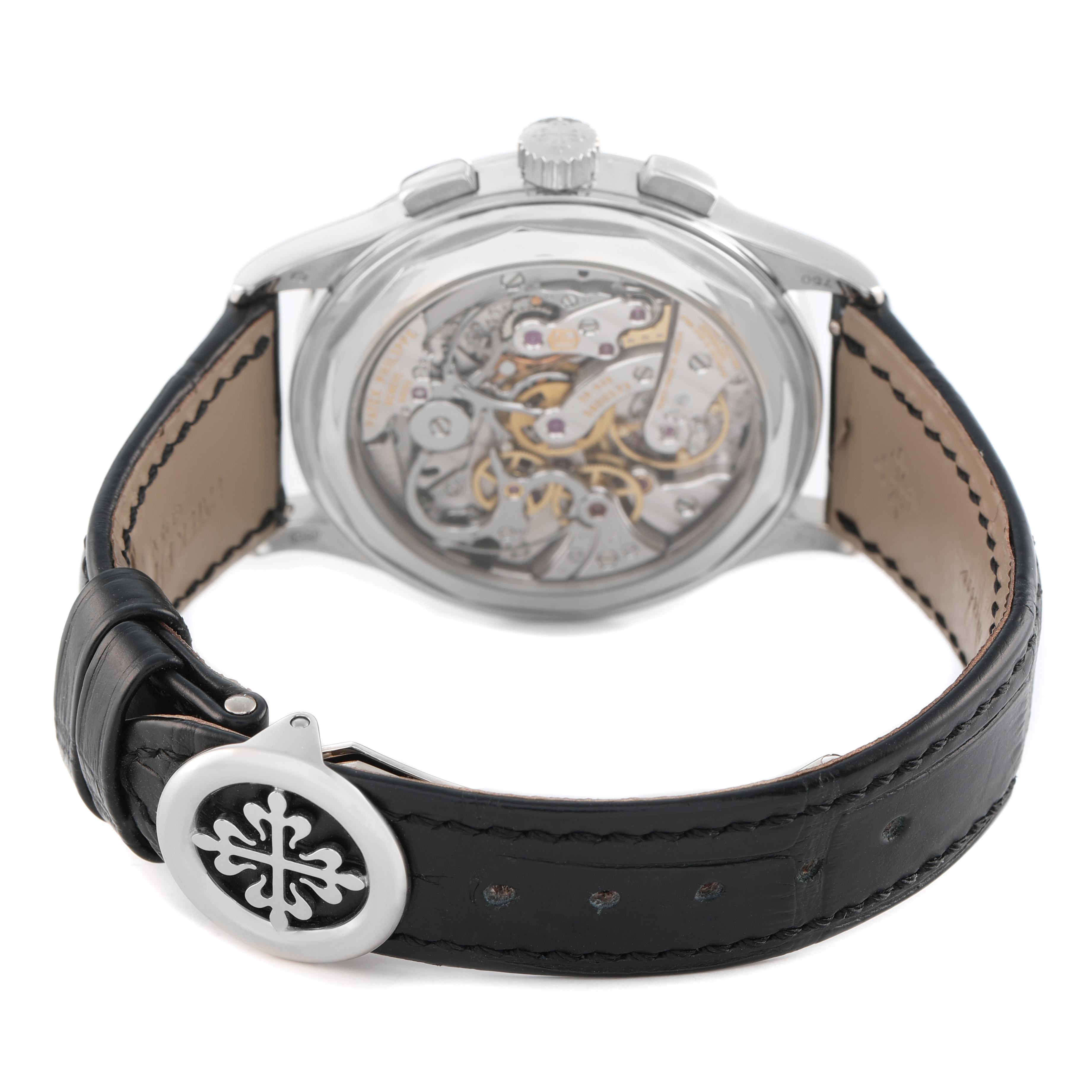 The Patek Philippe Complications 5170G-001 Men's White Gold Silver Dial watch is shown from the back, highlighting the exposed movement and leather strap.