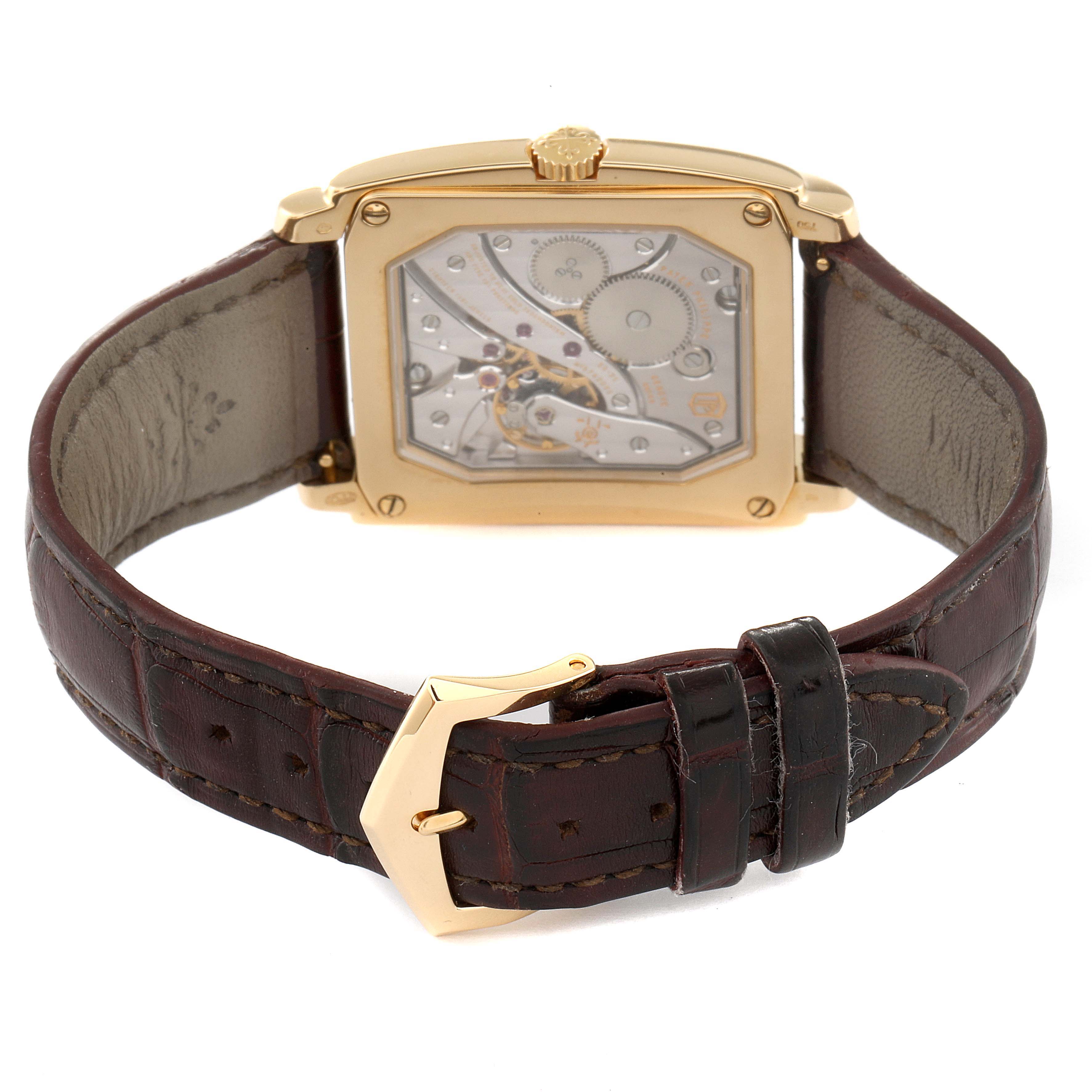 This image shows the back view of a Patek Philippe Gondolo 5124J Men's Yellow Gold Silver Dial 5124J Men's Yellow Gold Silver Dial watch, highlighting its movement and leather strap.