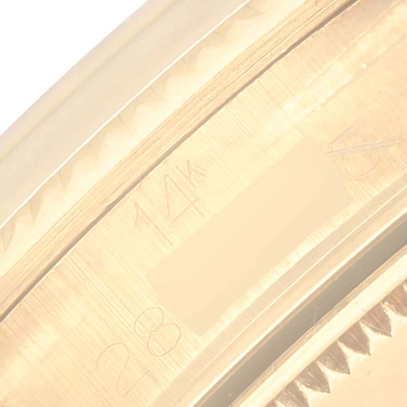 This image shows a close-up of the inside of the bezel and case edge of a Vintage Collection Rolex watch, highlighting "14k" and partial engravings.