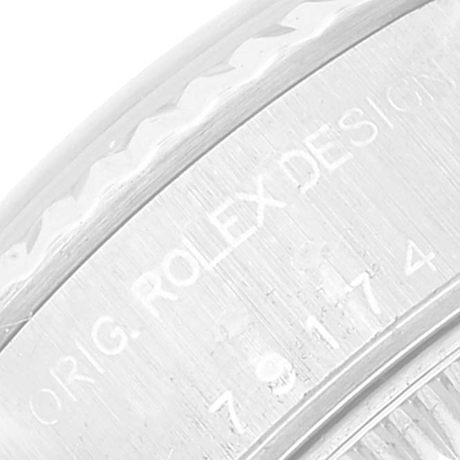 This close-up image shows the engraved text on the side of a Rolex Datejust 79174 Women's Stainless Steel Black Dial 79174 Women's Stainless Steel Black Dial model watch case.
