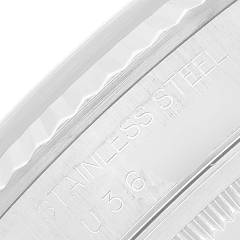 Close-up view of the side of the bezel and the stamped "STAINLESS STEEL" text on a Rolex Datejust 16234 Men's Stainless Steel Silver Dial 16234 Men's Stainless Steel Silver Dial watch.
