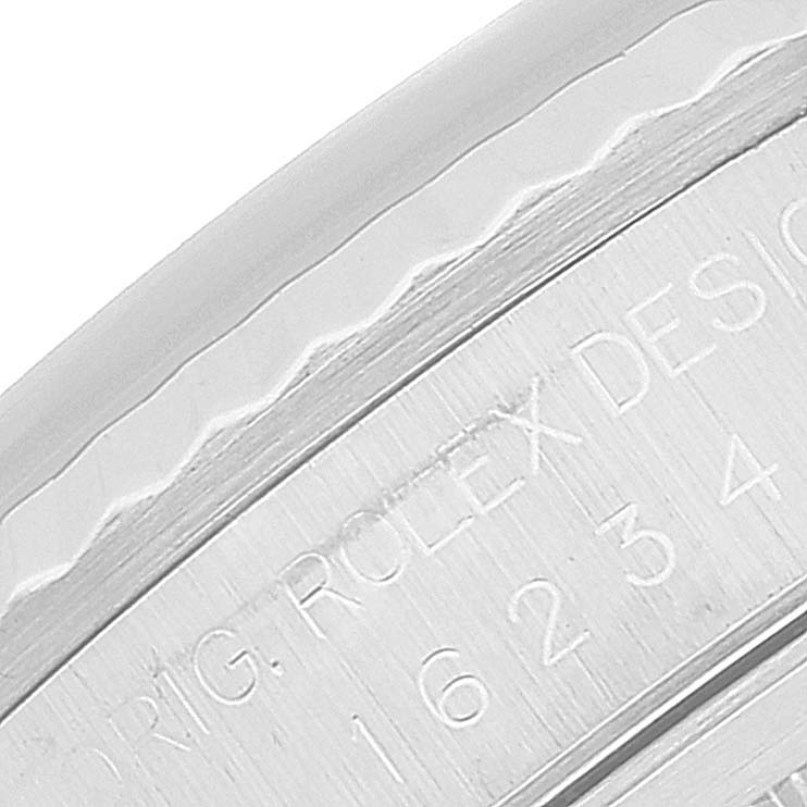 This close-up image shows the engraving on the case of a Rolex Datejust 16234 Men's Stainless Steel Silver Dial 16234 Men's Stainless Steel Silver Dial watch.