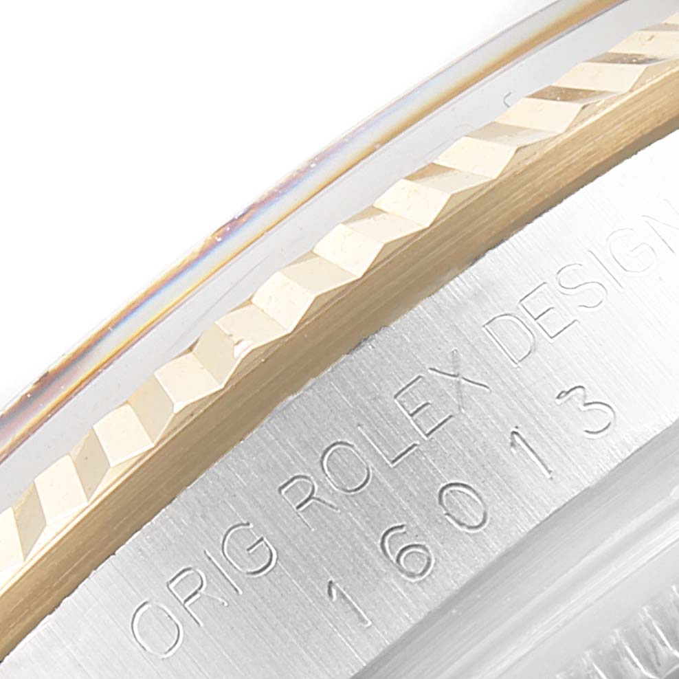 The image shows a close-up of the bezel and engraved case back of the Vintage Collection model by Rolex.