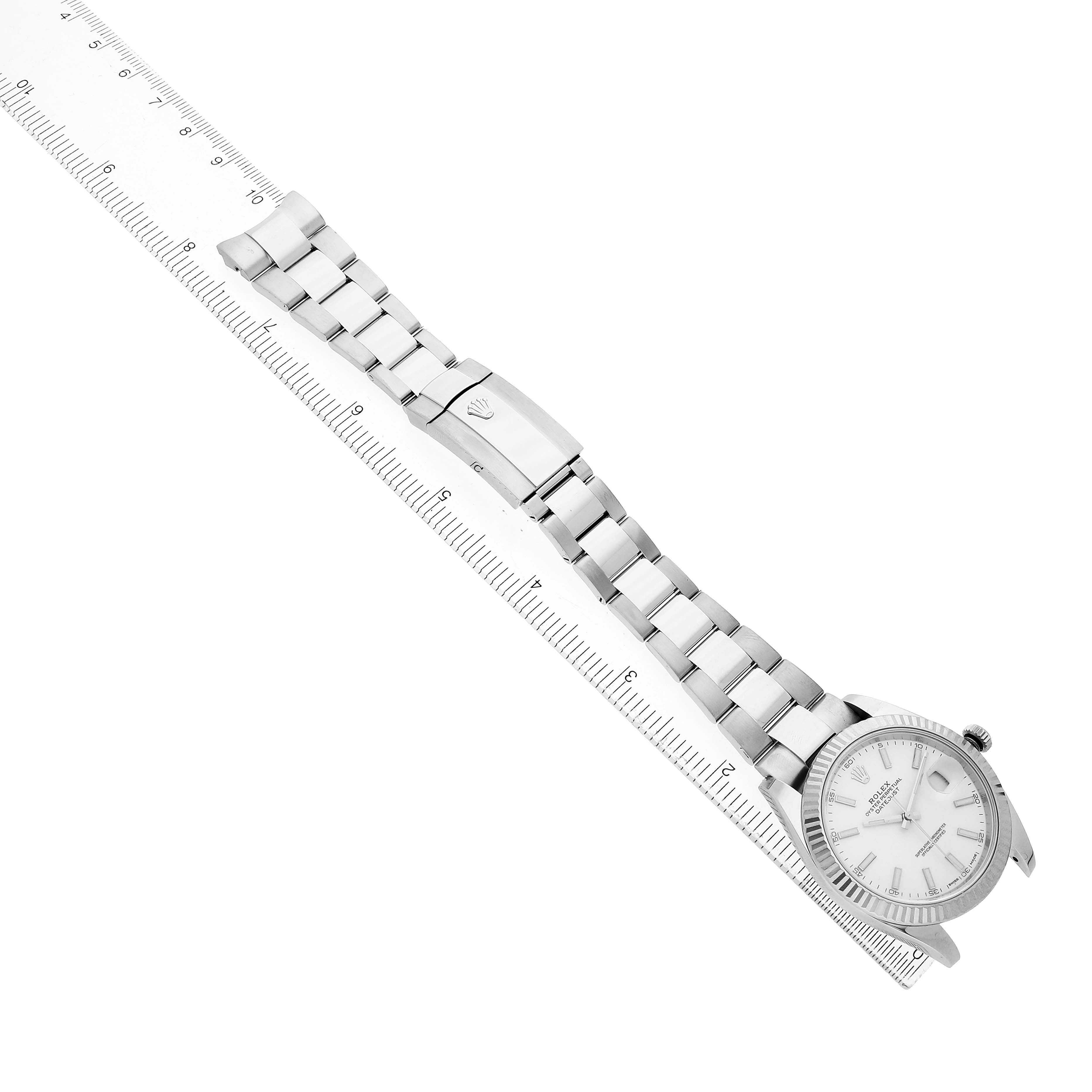 The image shows a Rolex Datejust 41 126334 Men's Stainless Steel White Dial watch at a diagonal angle, highlighting the face, bracelet, and clasp alongside a ruler.