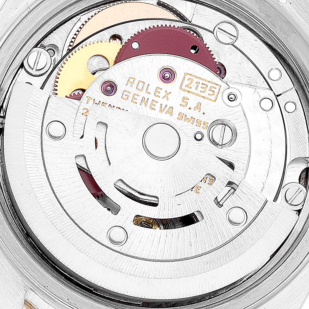 The image shows a close-up view of the internal mechanism of a Rolex Datejust 69173 Women's Steel and Gold (two tone) Champagne Dial 69173 Women's Steel and Gold (two tone) Champagne Dial model watch, highlighting gears and engravings.