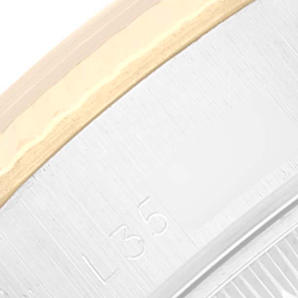 This close-up image shows a portion of the case of a Rolex Datejust 69173 Women's Steel and Gold (two tone) Champagne Dial 69173 Women's Steel and Gold (two tone) Champagne Dial watch, highlighting the metal construction and part of a reference number.