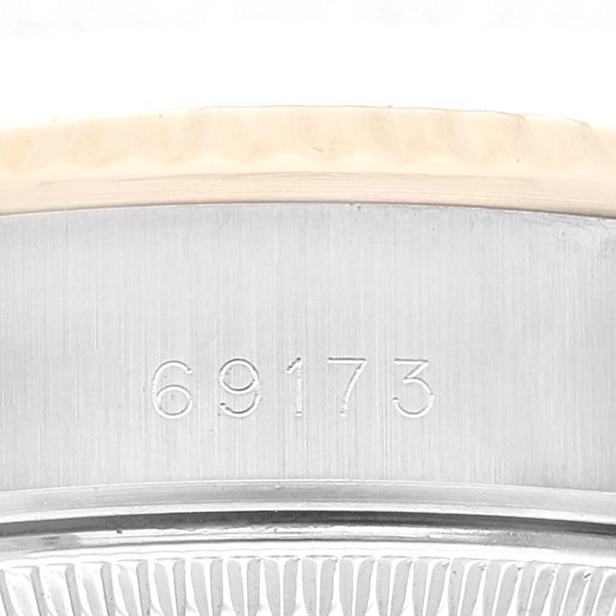 This image shows the engraved serial number on the side of the case of a Rolex Datejust 69173 Women's Steel and Gold (two tone) Champagne Dial 69173 Women's Steel and Gold (two tone) Champagne Dial watch.