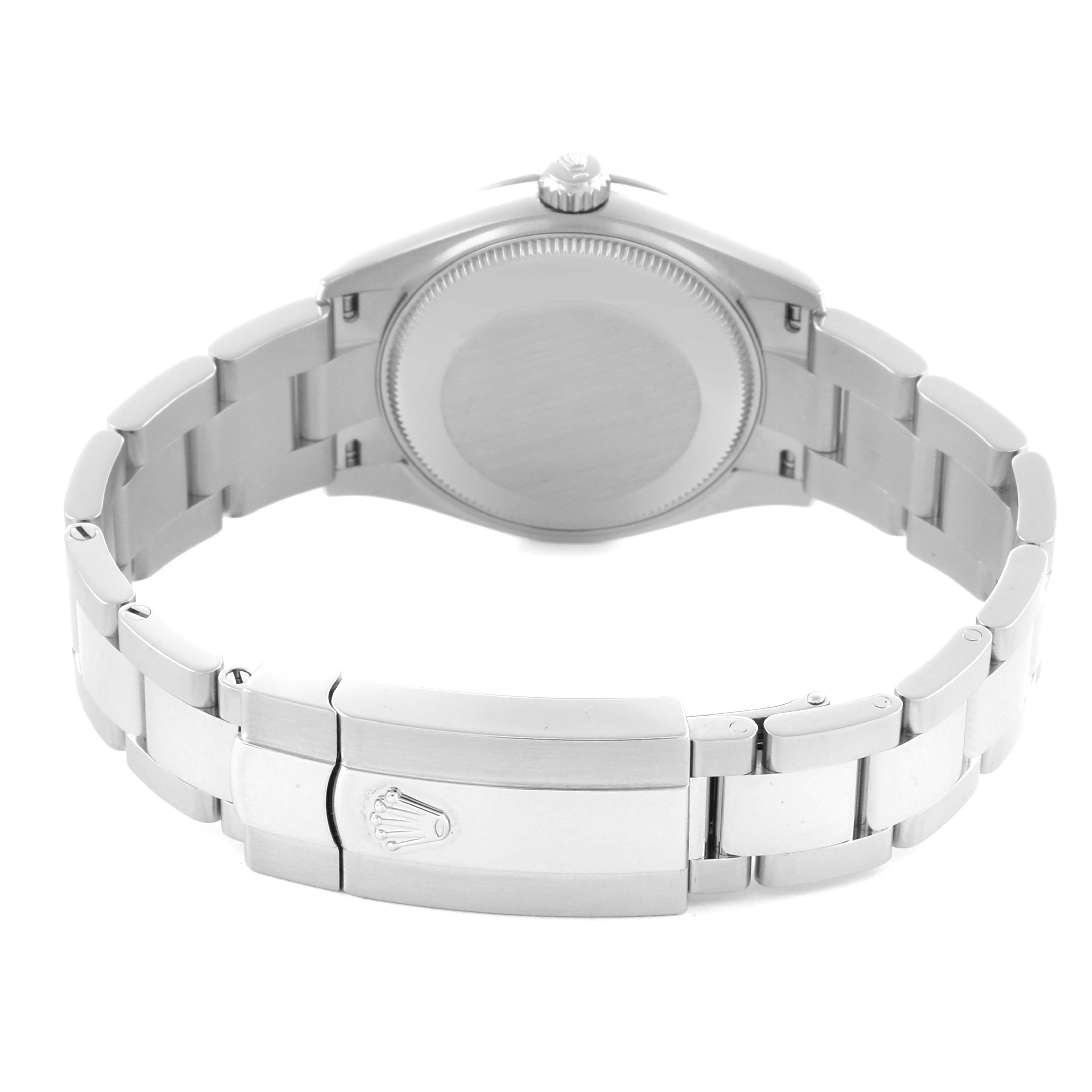The image shows the backside of a Mid-Size Rolex watch, highlighting its clasp and bracelet.