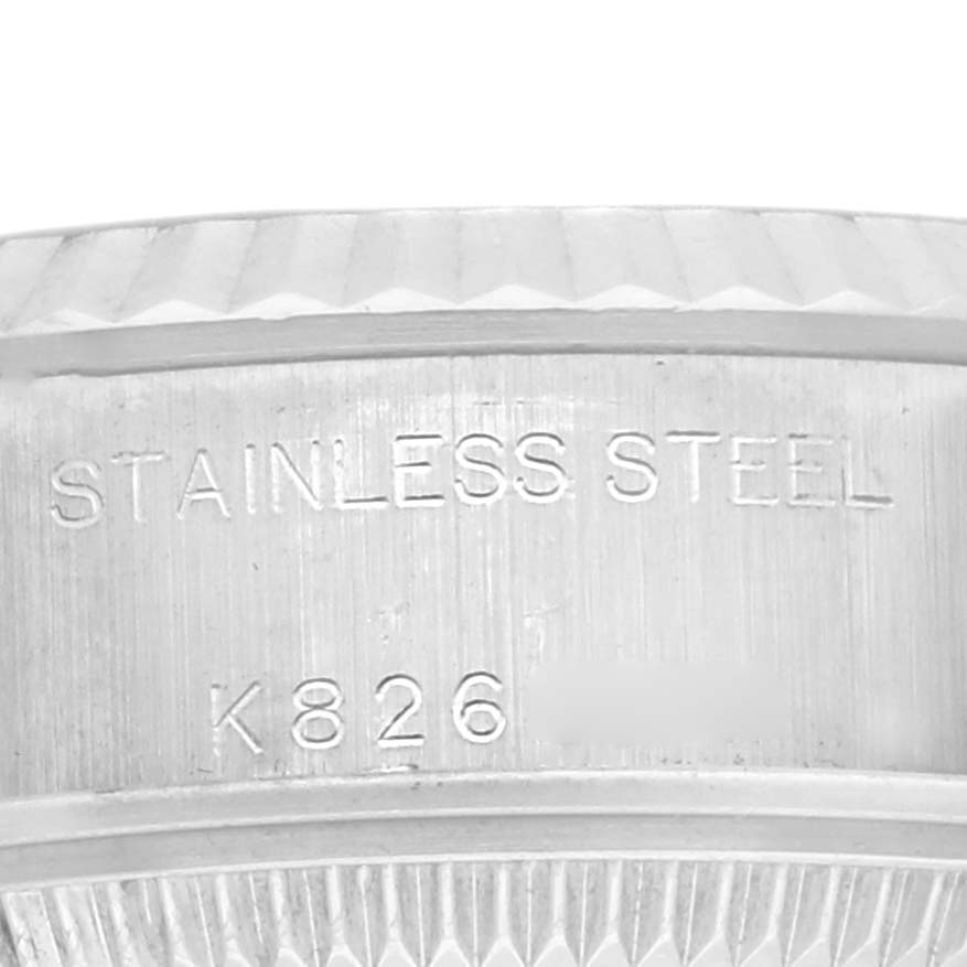 The image shows a close-up of the engraved stainless steel section on a Rolex Datejust 79174 Women's Stainless Steel Pink Dial 79174 Women's Stainless Steel Pink Dial watch bezel.