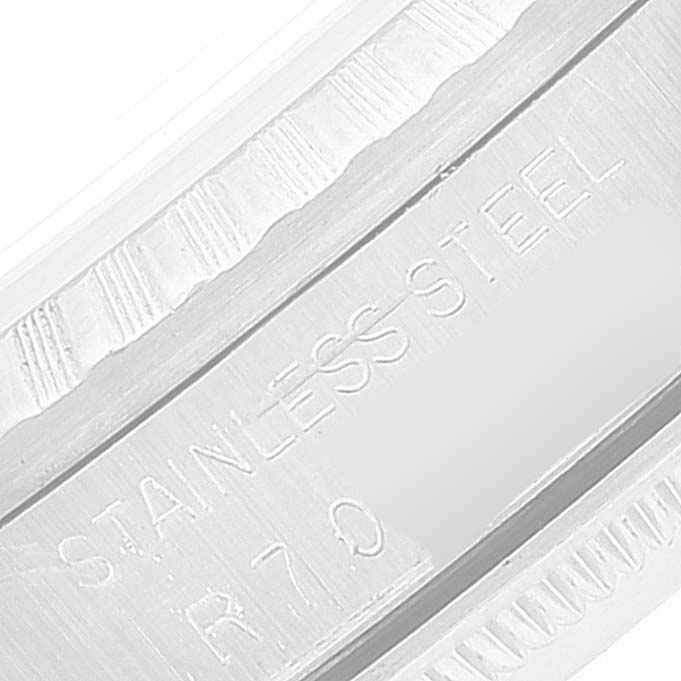 This close-up image shows the stainless steel bezel and part of the caseback of a Rolex Datejust 16220 Men's Stainless Steel Silver Dial 16220 Men's Stainless Steel Silver Dial watch.