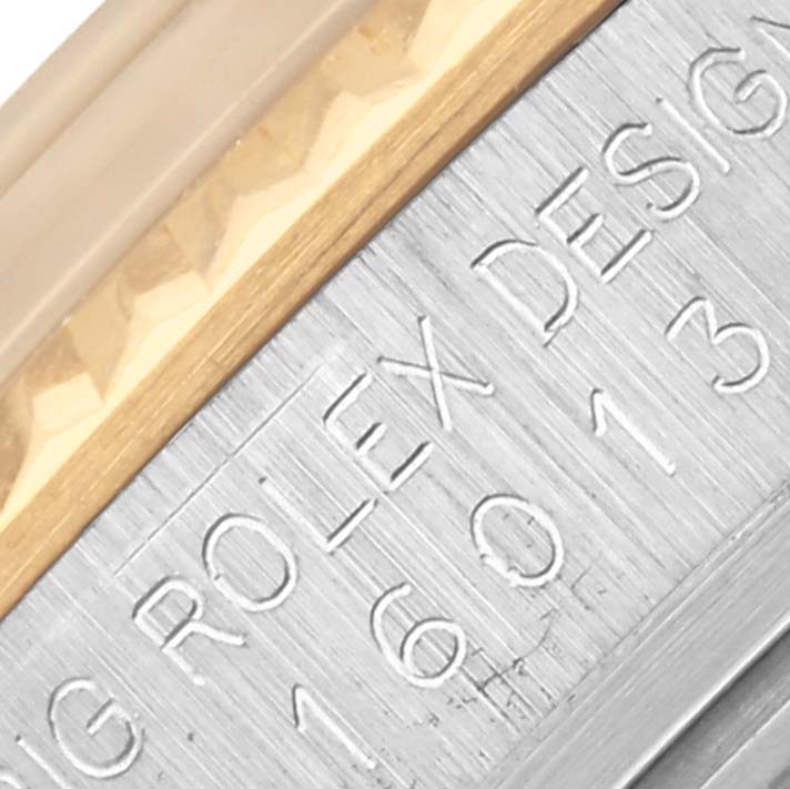 The image shows a close-up of the bezel and part of the engraved inner ring of the Rolex Datejust 16013 Men's Steel and Gold (two tone) Silver Dial 16013 Men's Steel and Gold (two tone) Silver Dial watch.