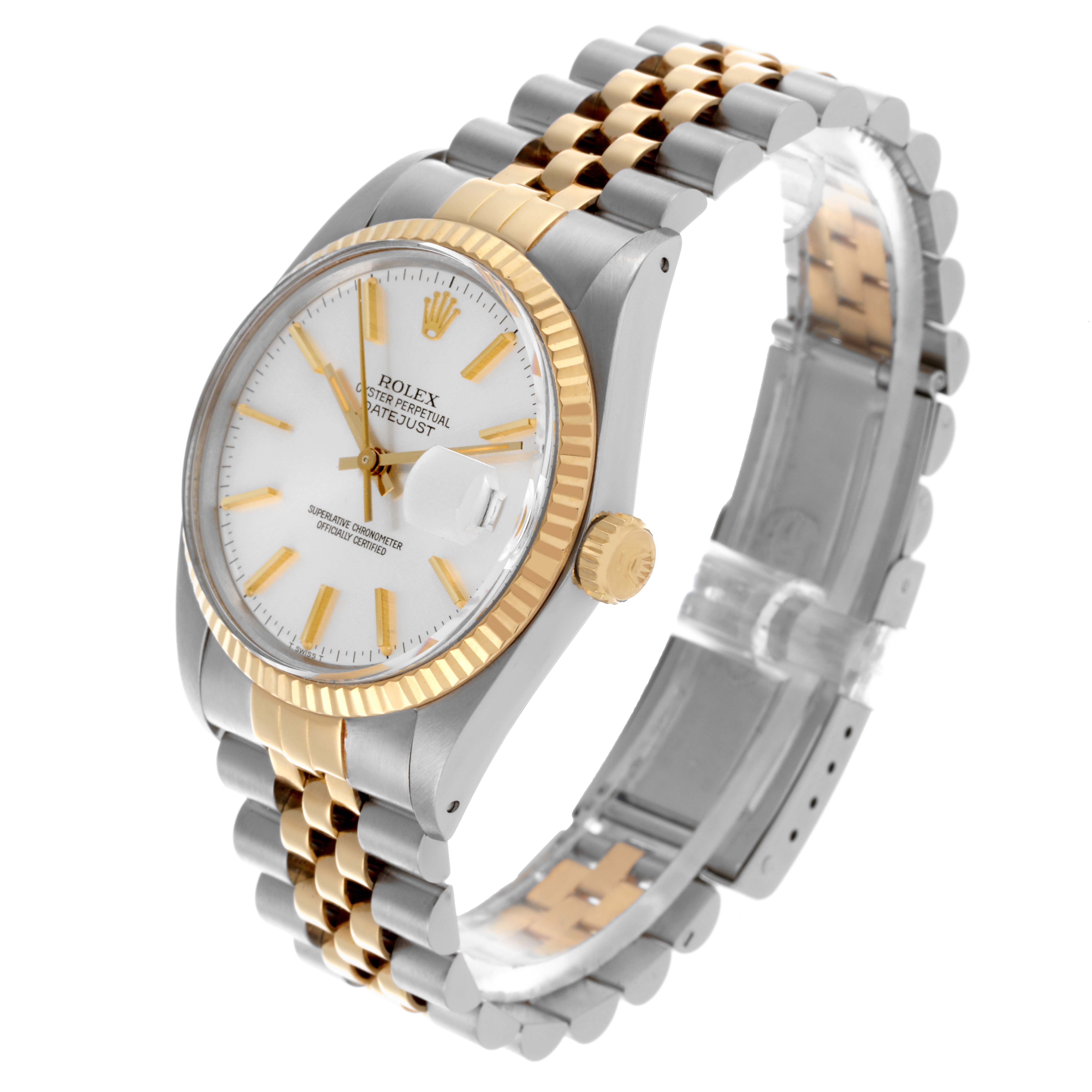 The Rolex Datejust 16013 Men's Steel and Gold (two tone) Silver Dial 16013 Men's Steel and Gold (two tone) Silver Dial watch is shown at a three-quarter angle, displaying its white dial, gold fluted bezel, and two-tone Jubilee bracelet.