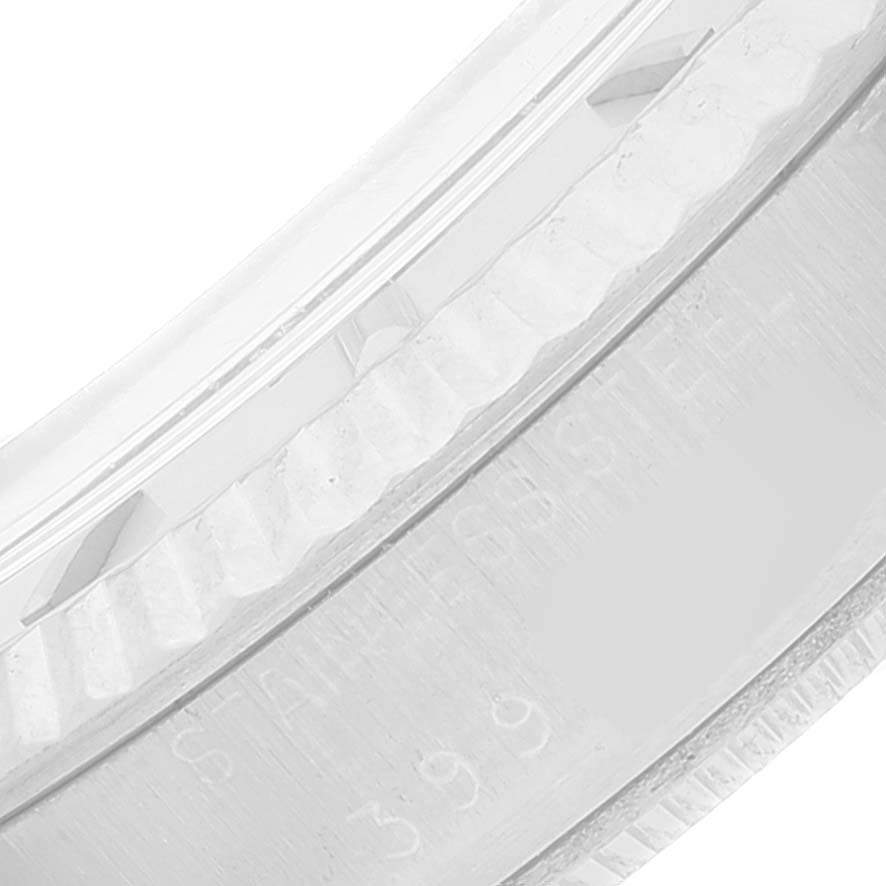 This close-up image shows the bezel and part of the case of a Rolex Vintage Collection 1601 Men's Stainless Steel Silver Dial 1601 Men's Stainless Steel Silver Dial watch, highlighting the "Stainless Steel" engraving.