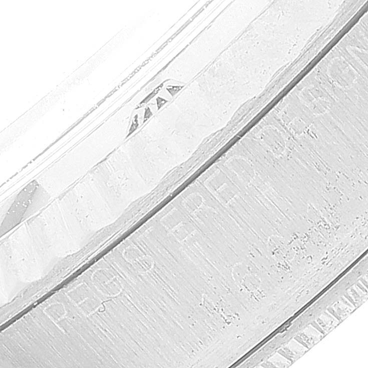 This image shows a close-up of the bezel and part of the case of the Rolex Vintage Collection 1601 Men's Stainless Steel Silver Dial 1601 Men's Stainless Steel Silver Dial watch.