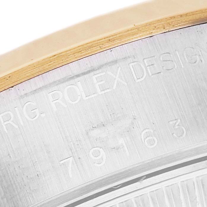 This image shows a close-up of the engraved serial number on the bezel of a Rolex Datejust 79163 Women's Steel and Gold (two tone) Champagne Dial 79163 Women's Steel and Gold (two tone) Champagne Dial watch.