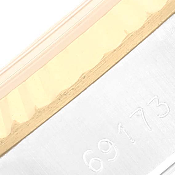 This image shows a close-up of a Datejust Rolex watch's serial number engraving on its side frame.