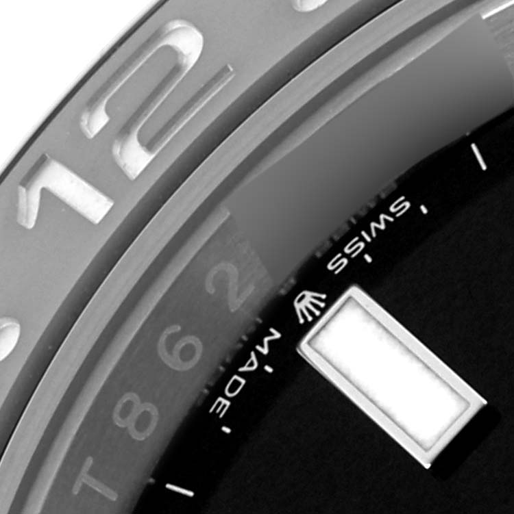 The image shows a close-up of the bezel and part of the dial of a Rolex GMT-Master 126710GRNR Men
s Stainless Steel Black Dial 126710GRNR Men
s Stainless Steel Black Dial watch.