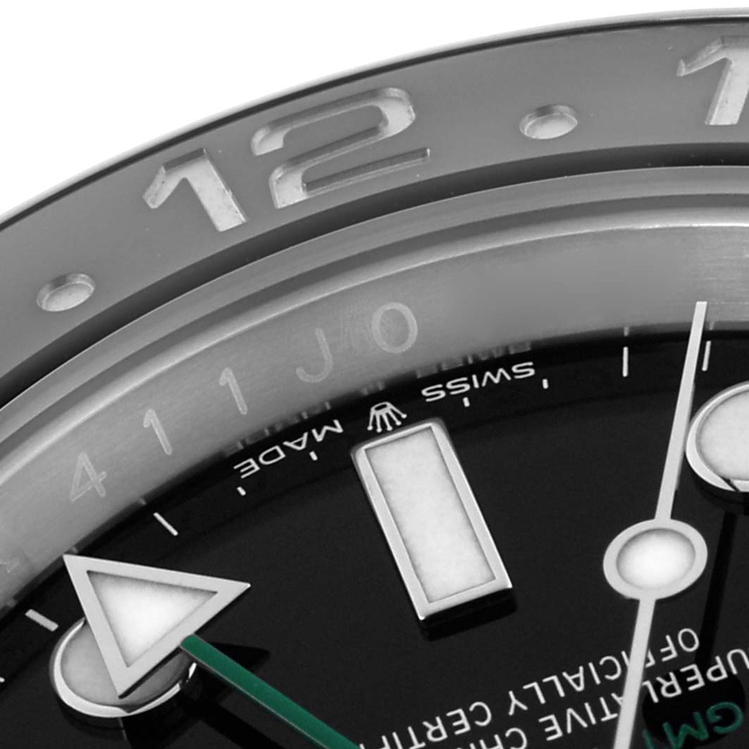 The image shows a close-up of the Rolex GMT-Master 126710GRNR Men's Stainless Steel Black Dial 126710GRNR Men's Stainless Steel Black Dial watch face, focusing on the bezel, hour marker, and hands.
