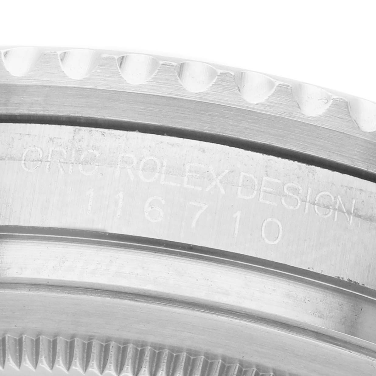 The image shows a close-up of the side of a Rolex GMT-Master 116710 Men's Stainless Steel Black Dial, focusing on the engraved model number and bezel edge.