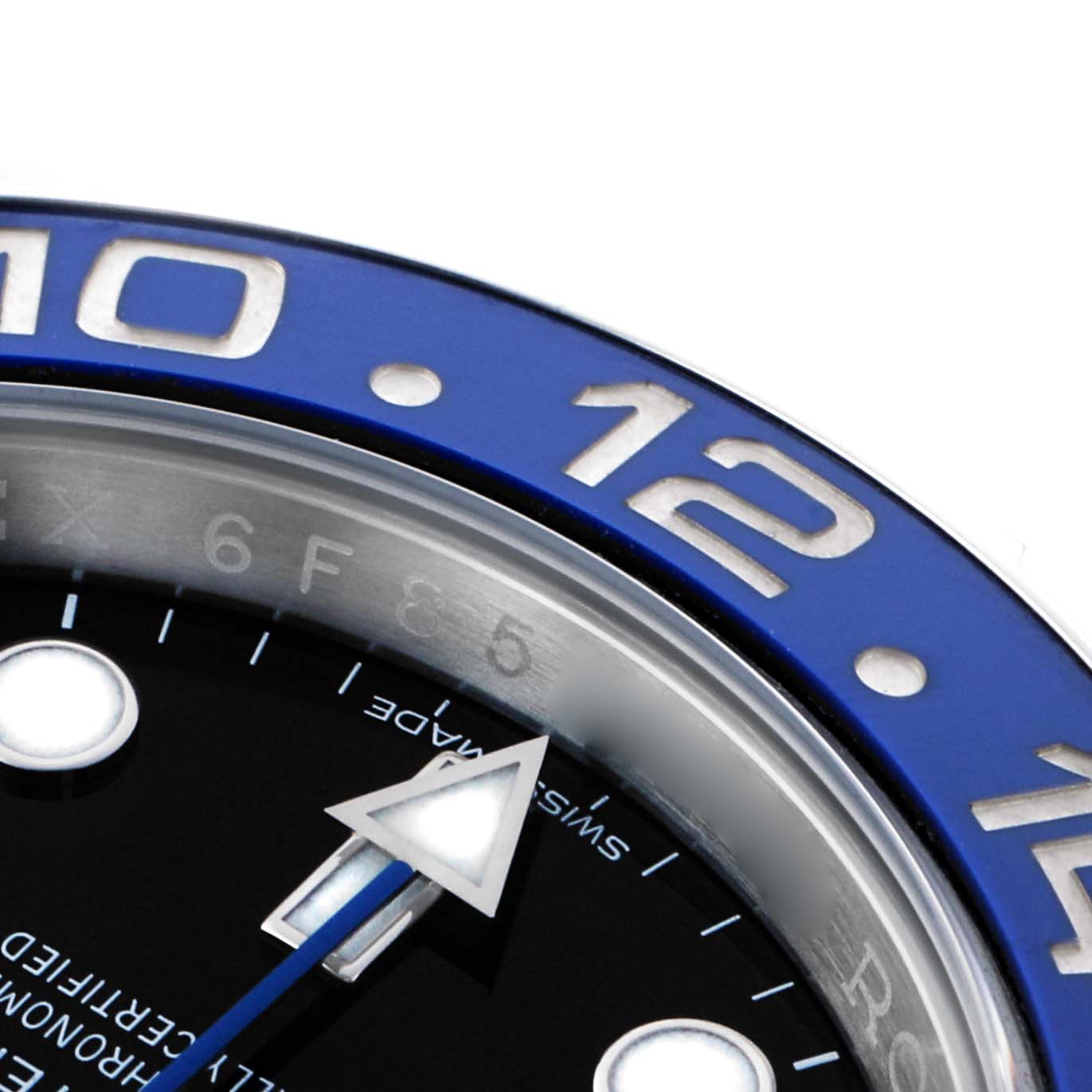 The image shows a close-up of the Rolex GMT-Master 116710 Men's Stainless Steel Black Dial's bezel, partial dial, and hour markers.