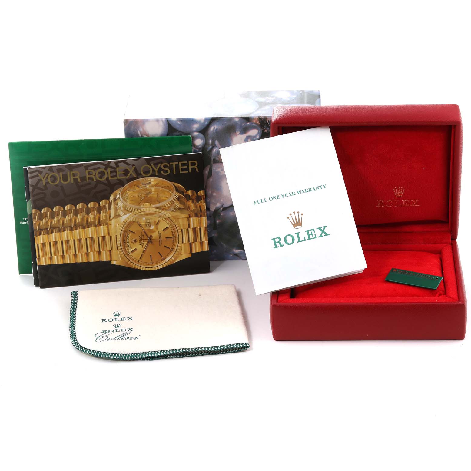 The image shows packaging, booklets, and warranty card for a Rolex Oyster Perpetual 76094 Women's Stainless Steel Blue Dial 76094 Women's Stainless Steel Blue Dial, but not the watch itself.