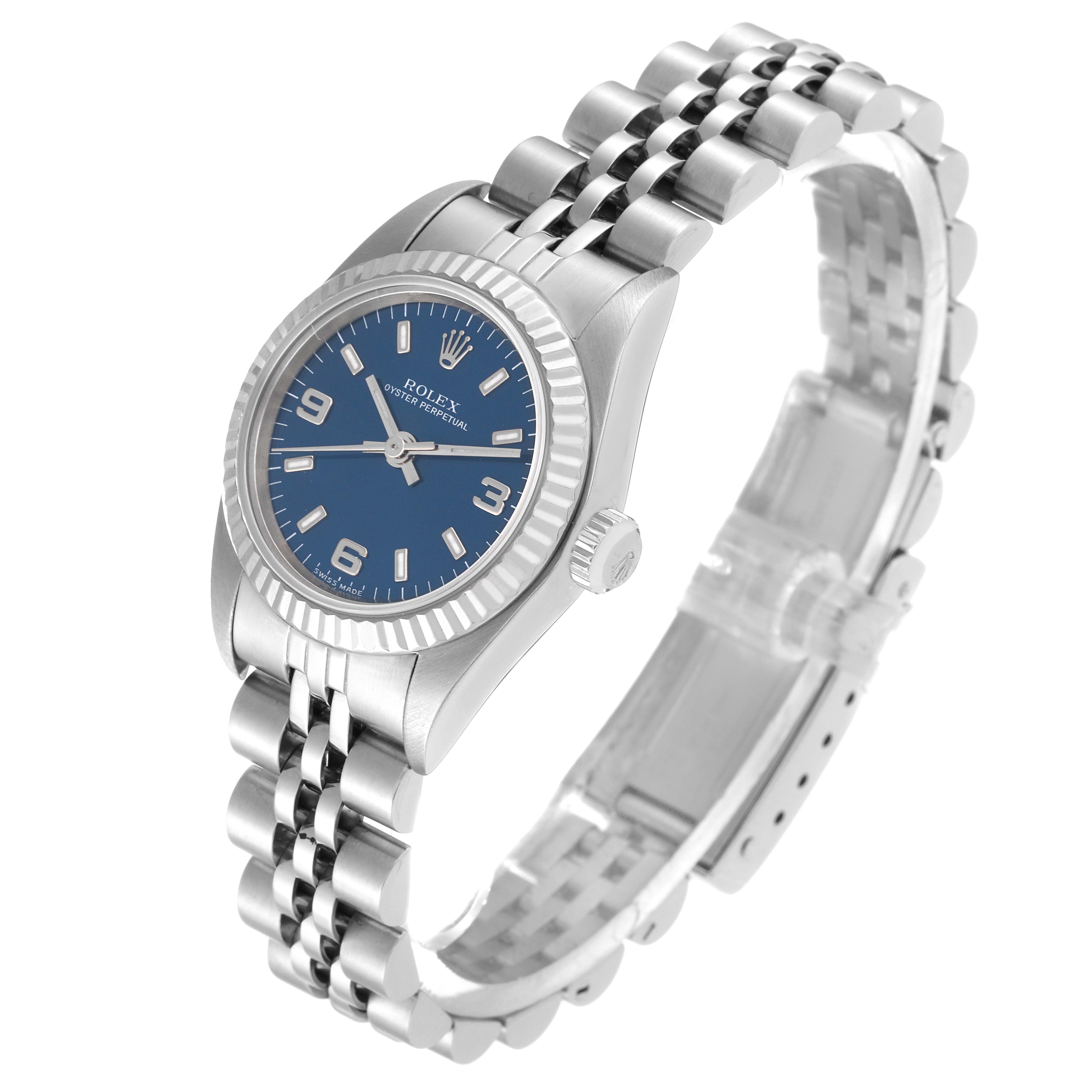 The image shows a Rolex Oyster Perpetual 76094 Women's Stainless Steel Blue Dial 76094 Women's Stainless Steel Blue Dial watch from a slight angle, highlighting the blue dial, fluted bezel, and jubilee bracelet.