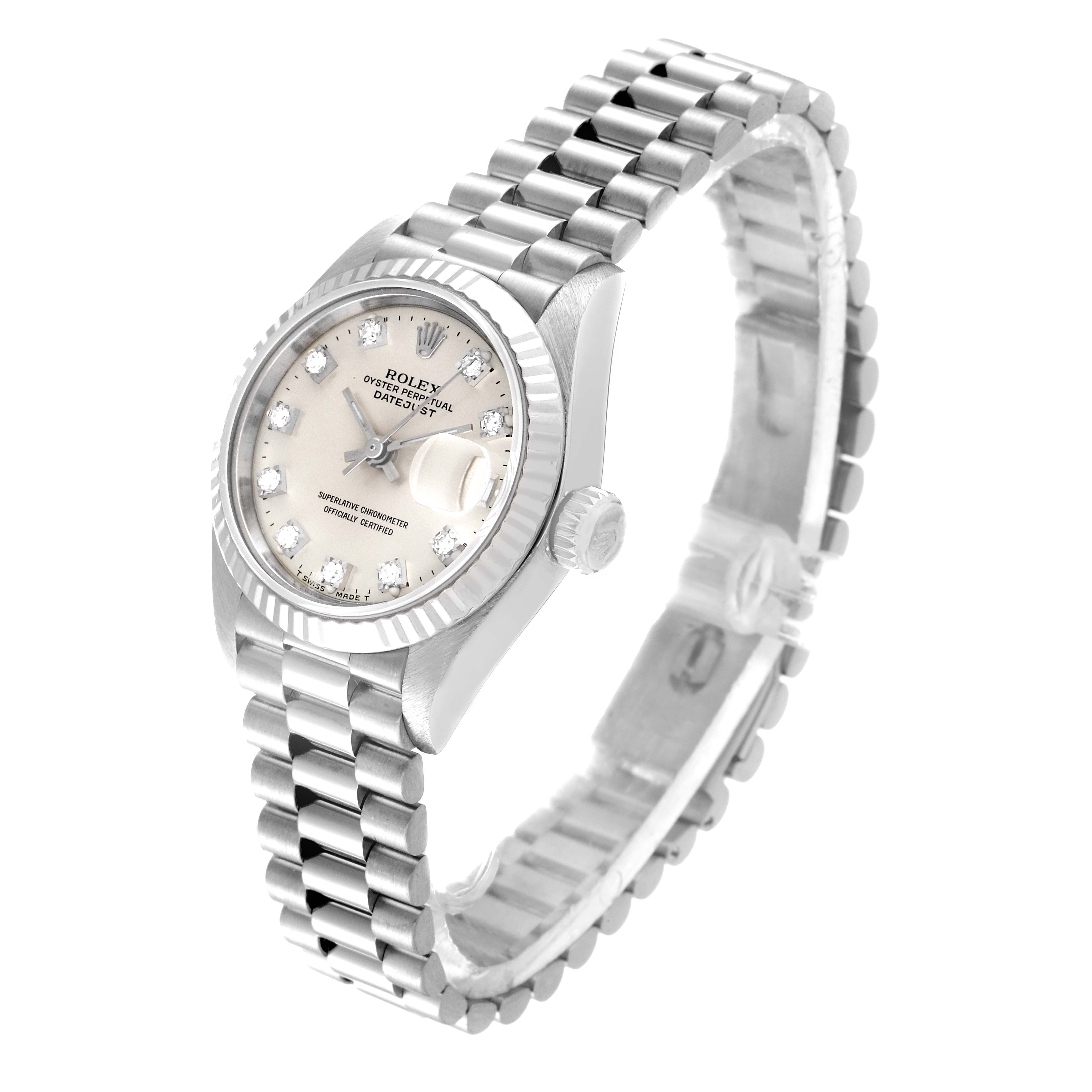 The image shows a Rolex President 69179 Women
s White Gold Silver Dial 69179 Women
s White Gold Silver Dial model watch from a three-quarter angle, displaying its face, crown, and bracelet.