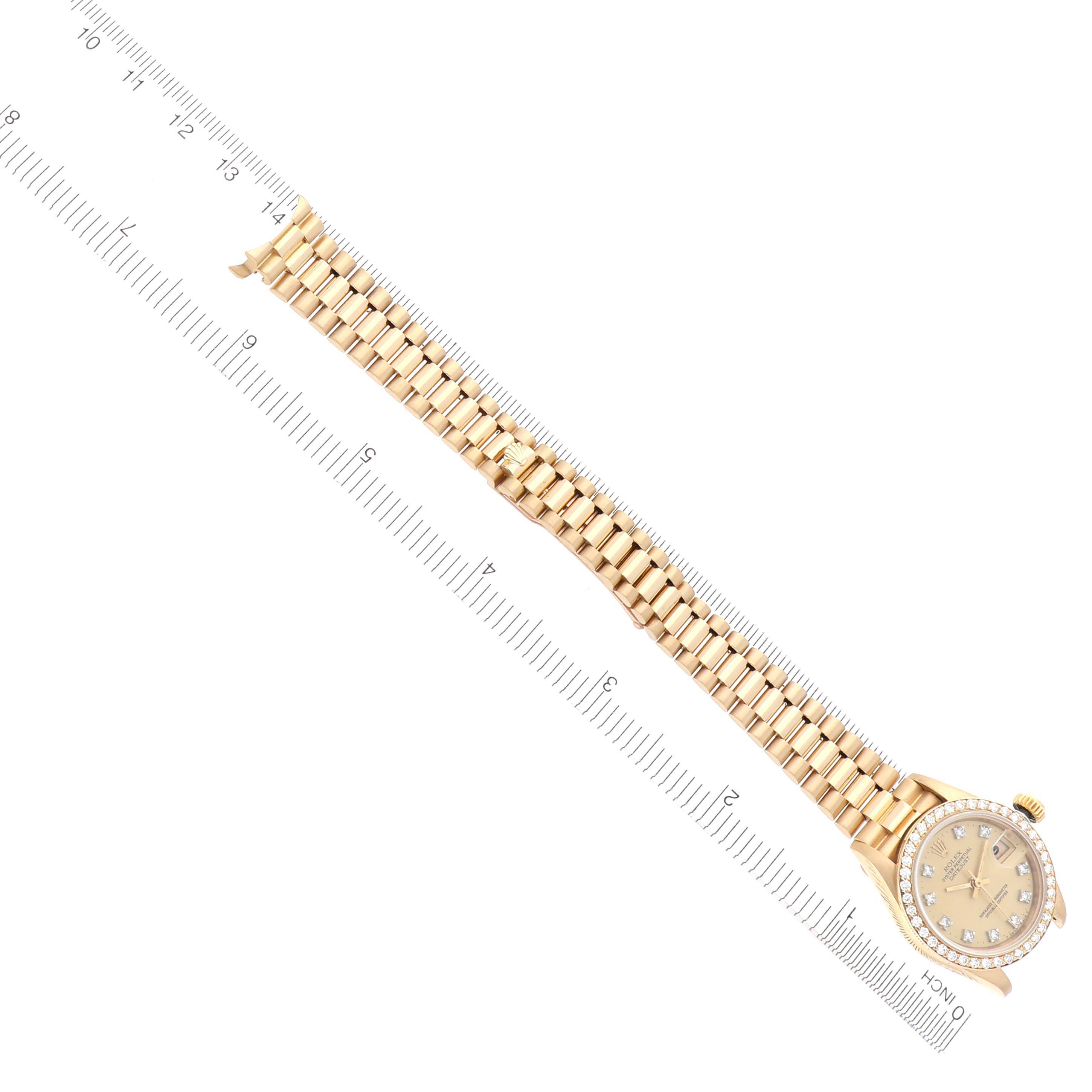 The image shows a Rolex President 69138 Women's Yellow Gold Champagne Dial 69138 Women's Yellow Gold Champagne Dial model watch at an oblique angle, highlighting the face and full bracelet length alongside a ruler.