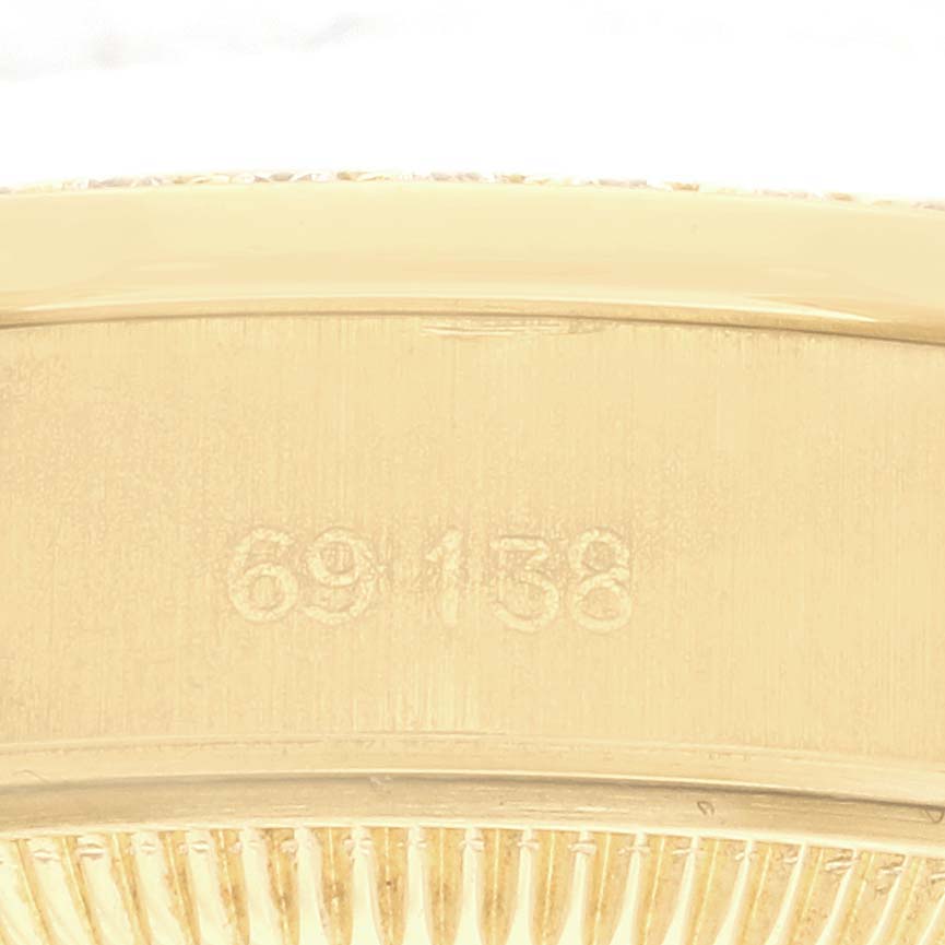 The image shows the side view of a Rolex President 69138 Women's Yellow Gold Champagne Dial 69138 Women's Yellow Gold Champagne Dial model, focusing on the reference number etched on the case.