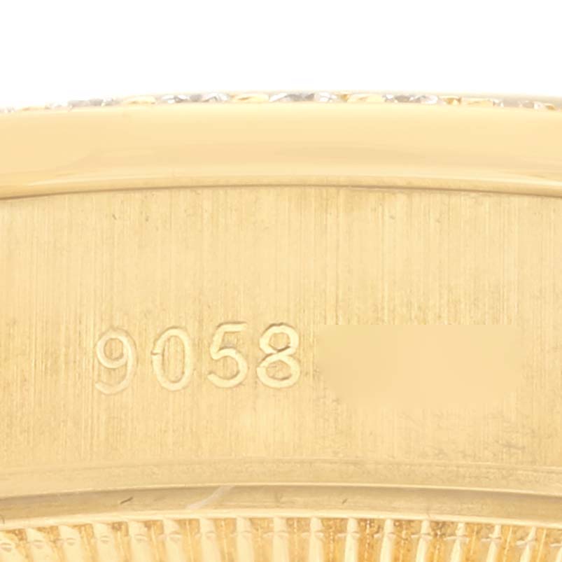The image shows a close-up of the side of the Rolex President 69138 Women's Yellow Gold Champagne Dial 69138 Women's Yellow Gold Champagne Dial watch, highlighting the engraved numbers on the case.