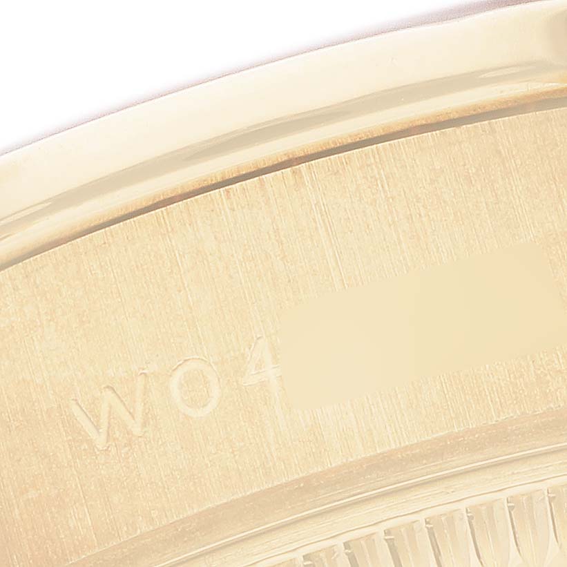 The image shows a close-up of the Rolex President 69158 Women's Yellow Gold Silver Dial model's case edge with engraved markings.