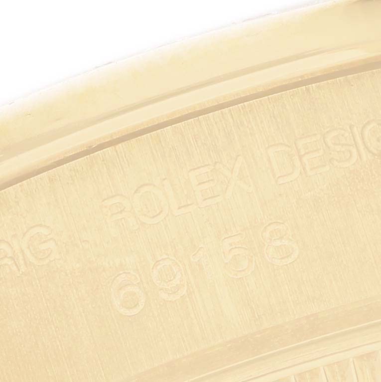 The image shows the engraved back side of a Rolex President 69158 Women's Yellow Gold Silver Dial watch, highlighting the model number.