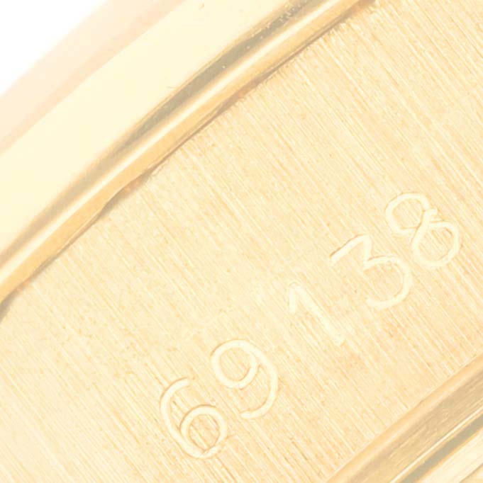 This is a close-up of the serial number engraving on the band of the Rolex President 69138 Women's Yellow Gold Mother of Pearl Dial 69138 Women's Yellow Gold Mother of Pearl Dial model watch.