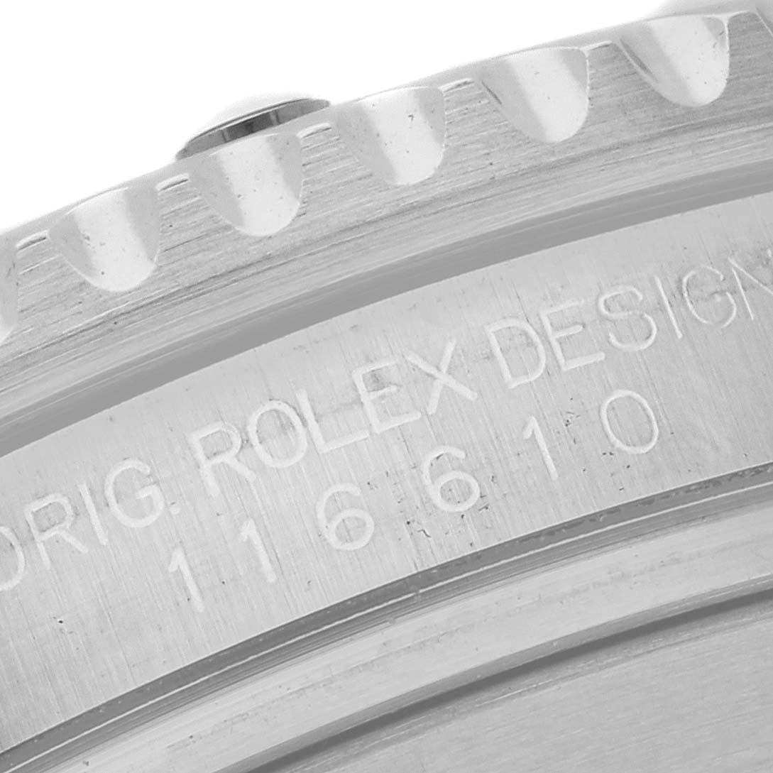 This image shows a close-up of the engraved edge on a Rolex Submariner 116610LV Men's Stainless Steel Green Dial 116610LV Men's Stainless Steel Green Dial model watch.
