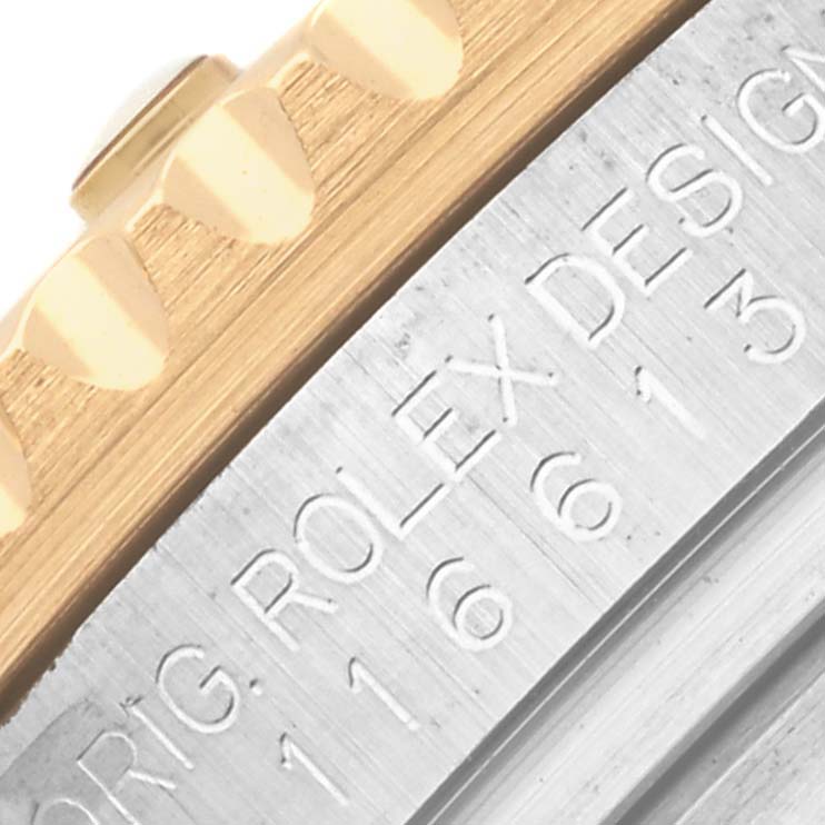 The image shows a close-up of the case side and engraved bezel of a Rolex Submariner 116613LB Men's Steel and Gold (two tone) Blue Dial 116613LB Men's Steel and Gold (two tone) Blue Dial model.