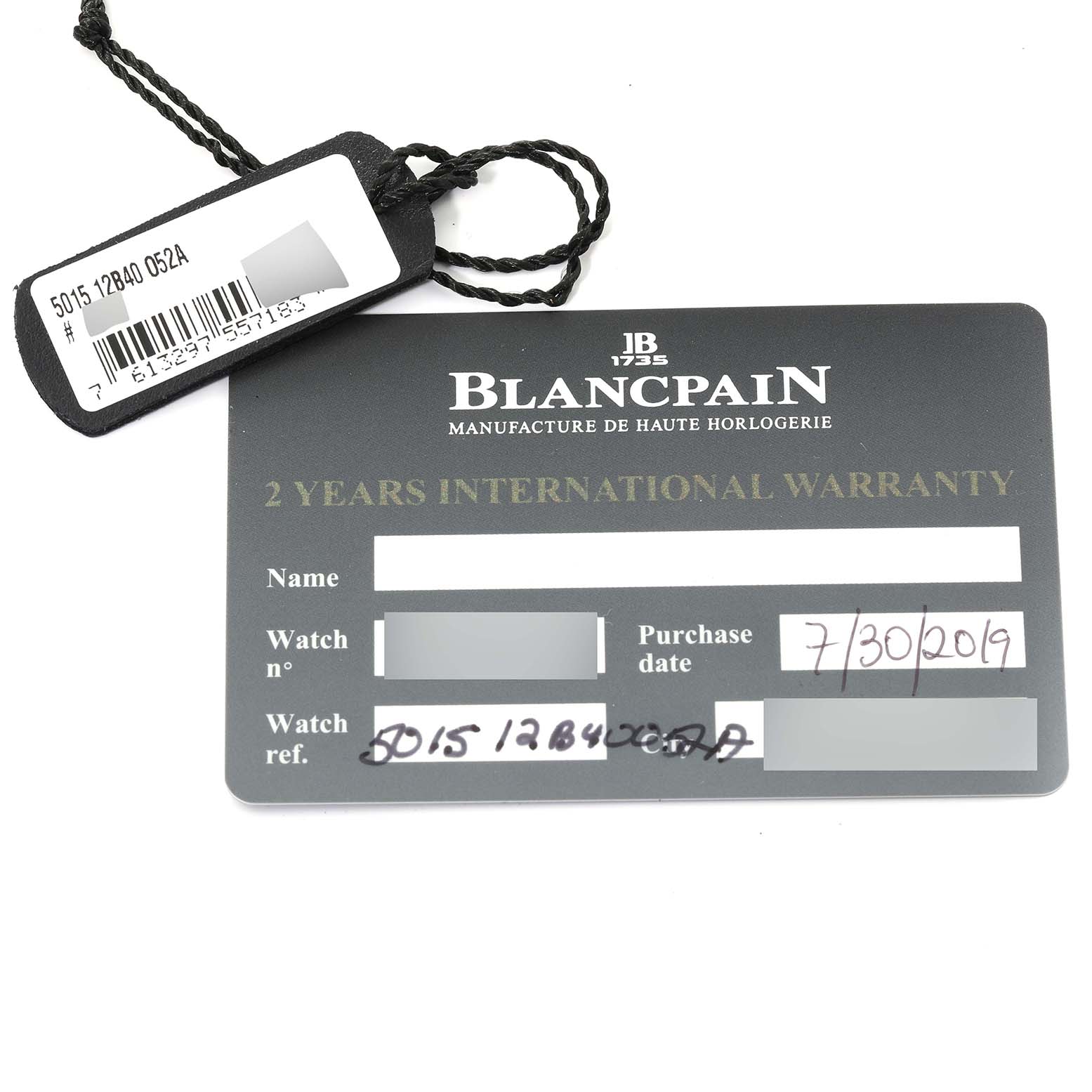 The image shows a warranty card and a tag for the Blancpain Fifty Fathoms 5015-12B40-052A Men's Titanium Blue Dial 5015-12B40-052A Men's Titanium Blue Dial watch, displaying purchase information and model details.