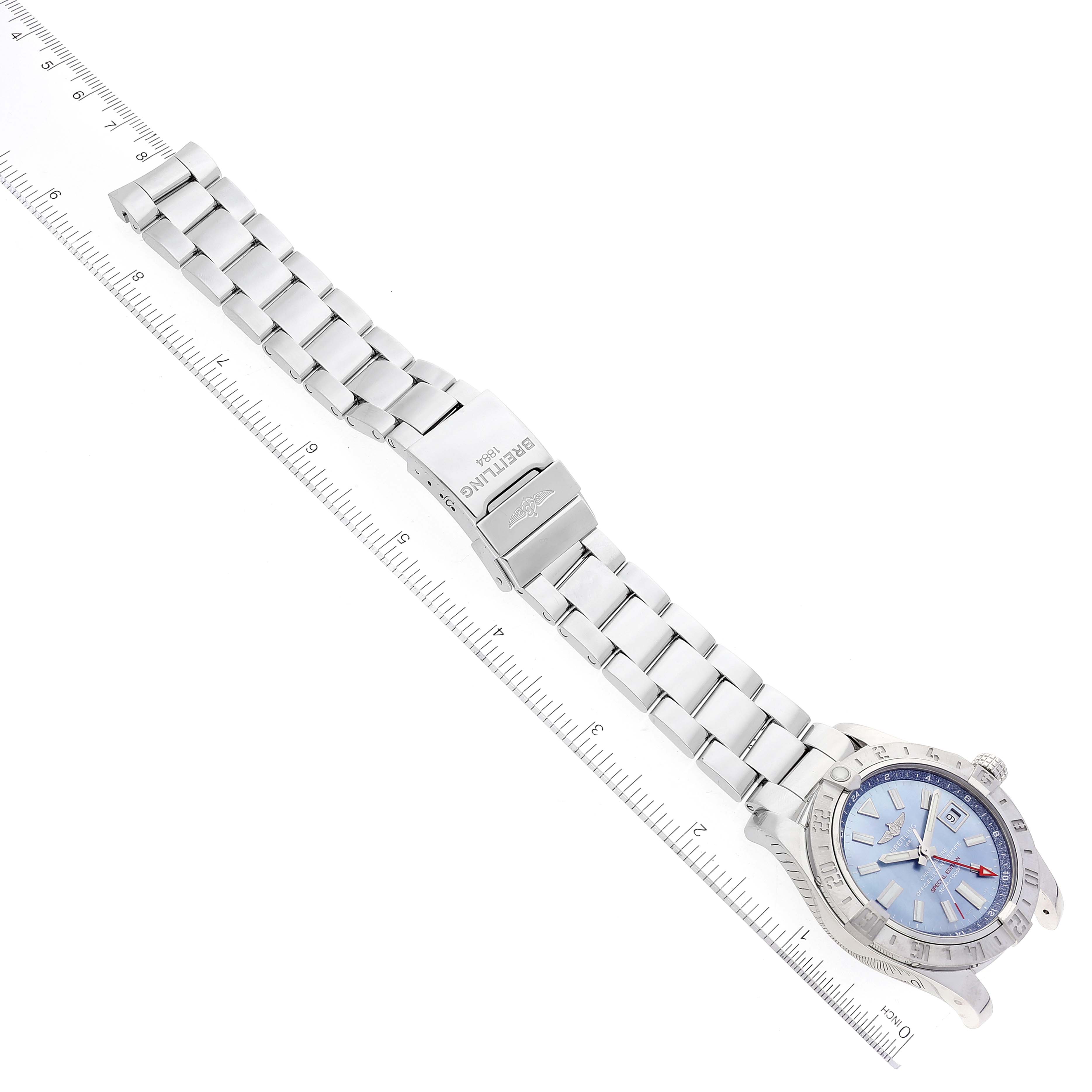 The image shows a Breitling Avenger A32390 Men's Stainless Steel Mother of Pearl Dial A32390 Men's Stainless Steel Mother of Pearl Dial watch from a top-down angle, including its metal bracelet and clasp.