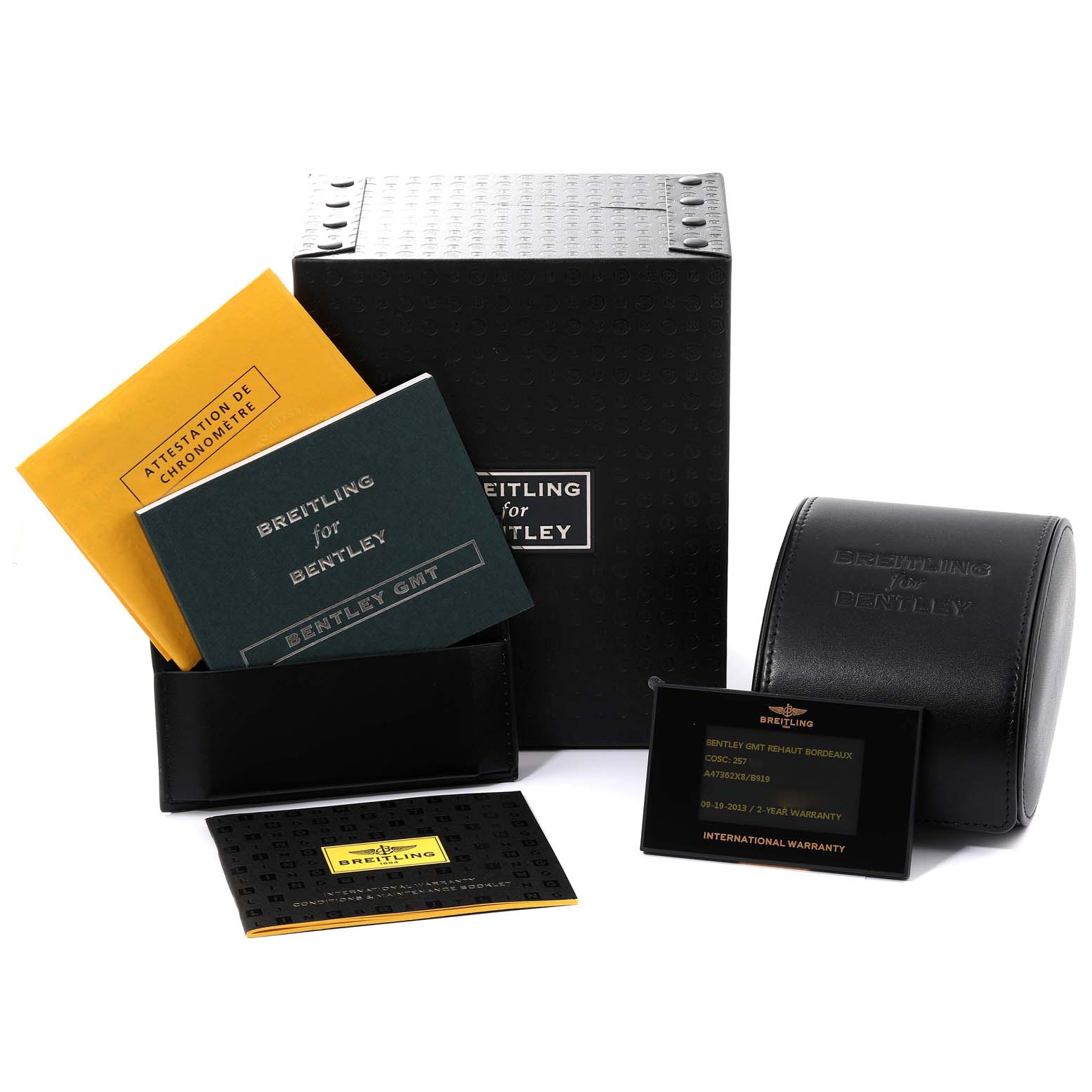 The image shows the packaging and accessories for a Bentley model by Breitling, including manuals, a warranty card, and a watch case.