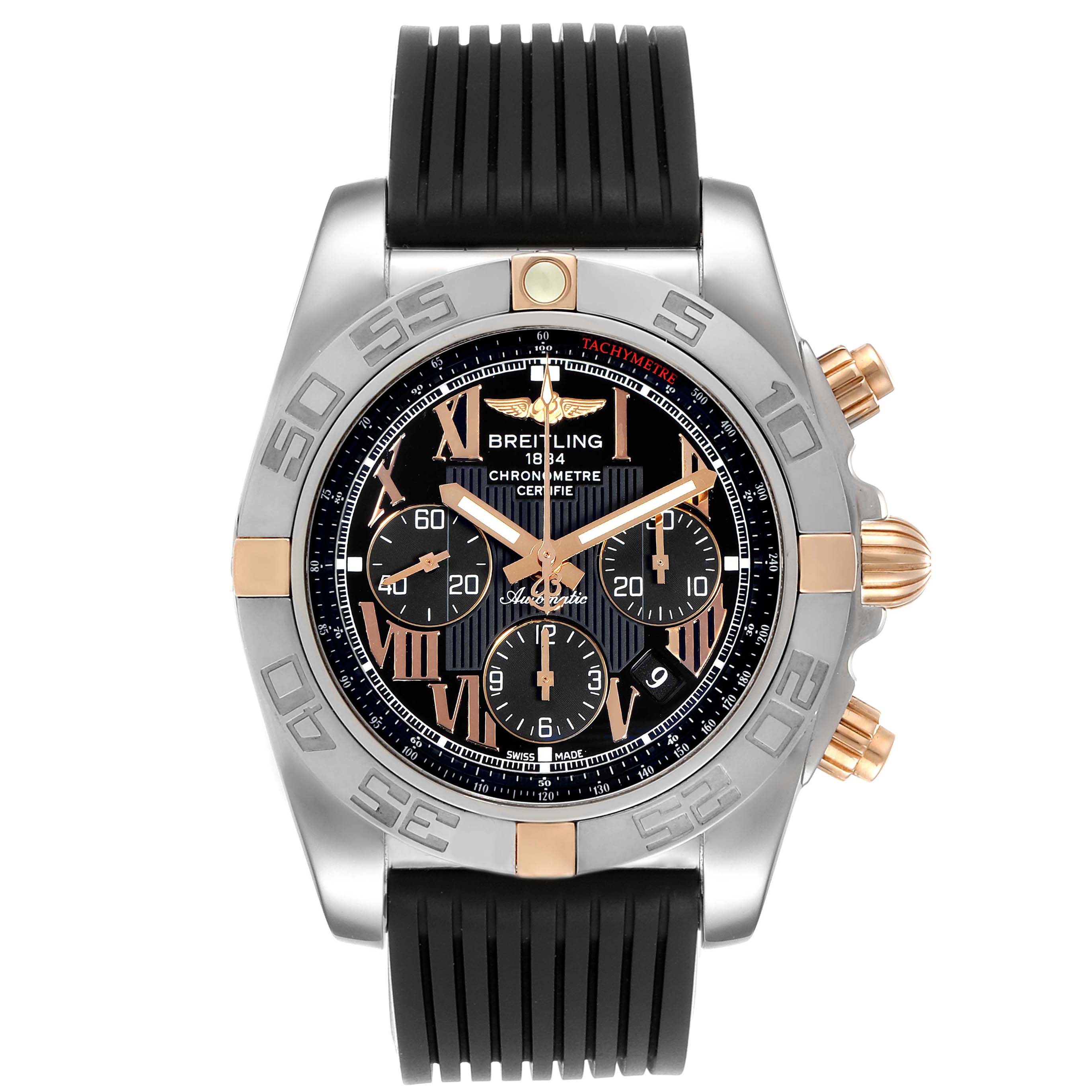 The image shows a Breitling Chronomat 1B0110 Men's Steel and Gold (two tone) Black Dial 1B0110 Men's Steel and Gold (two tone) Black Dial watch from a front angle, highlighting its black rubber strap, dial, and chronograph features.