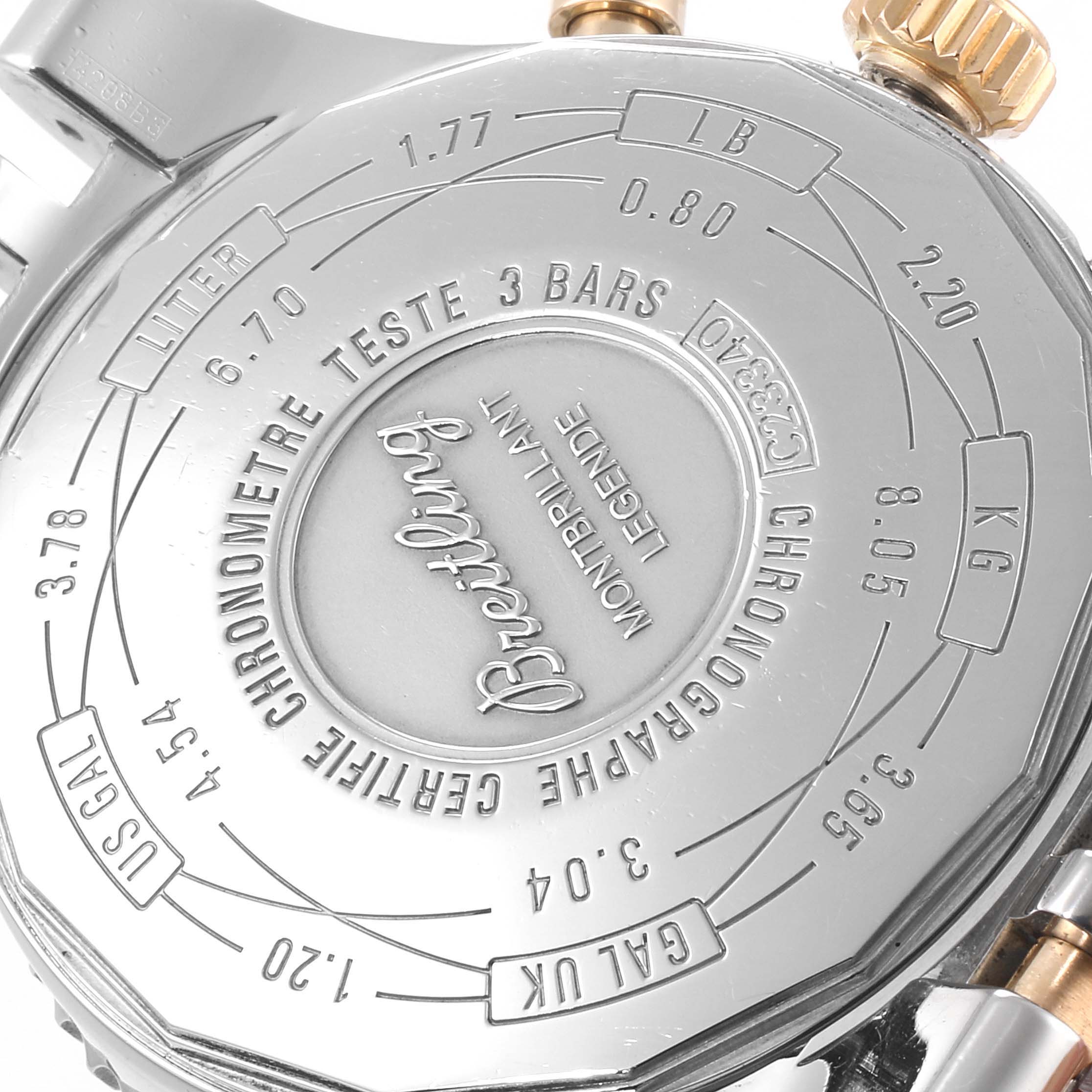 The image shows the back case of a Breitling Navitimer C23340 Men's Steel and Gold (two tone) Brown Dial C23340 Men's Steel and Gold (two tone) Brown Dial watch at an angled close-up, highlighting the engravings.