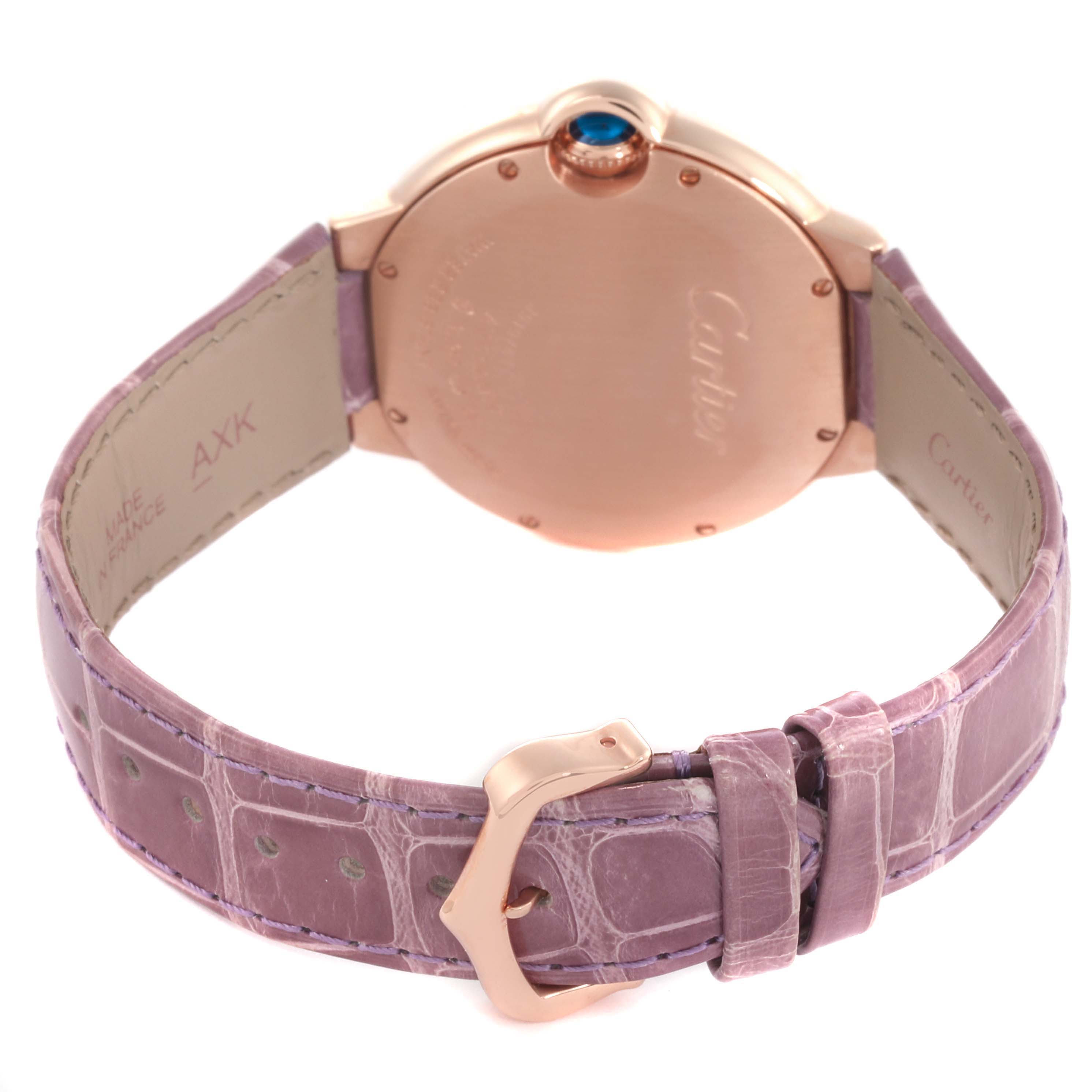 The image shows the back of a Cartier Ballon Bleu WJBB0010 Women's Rose Gold Silver Dial WJBB0010 Women's Rose Gold Silver Dial watch, highlighting the case, crown, and purple leather strap with a buckle.