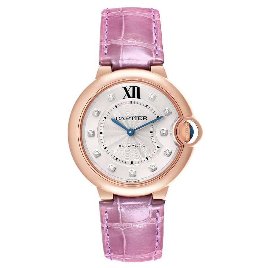 The Cartier Ballon Bleu watch is shown in a top view, displaying its face, rose gold case, and pink leather strap.